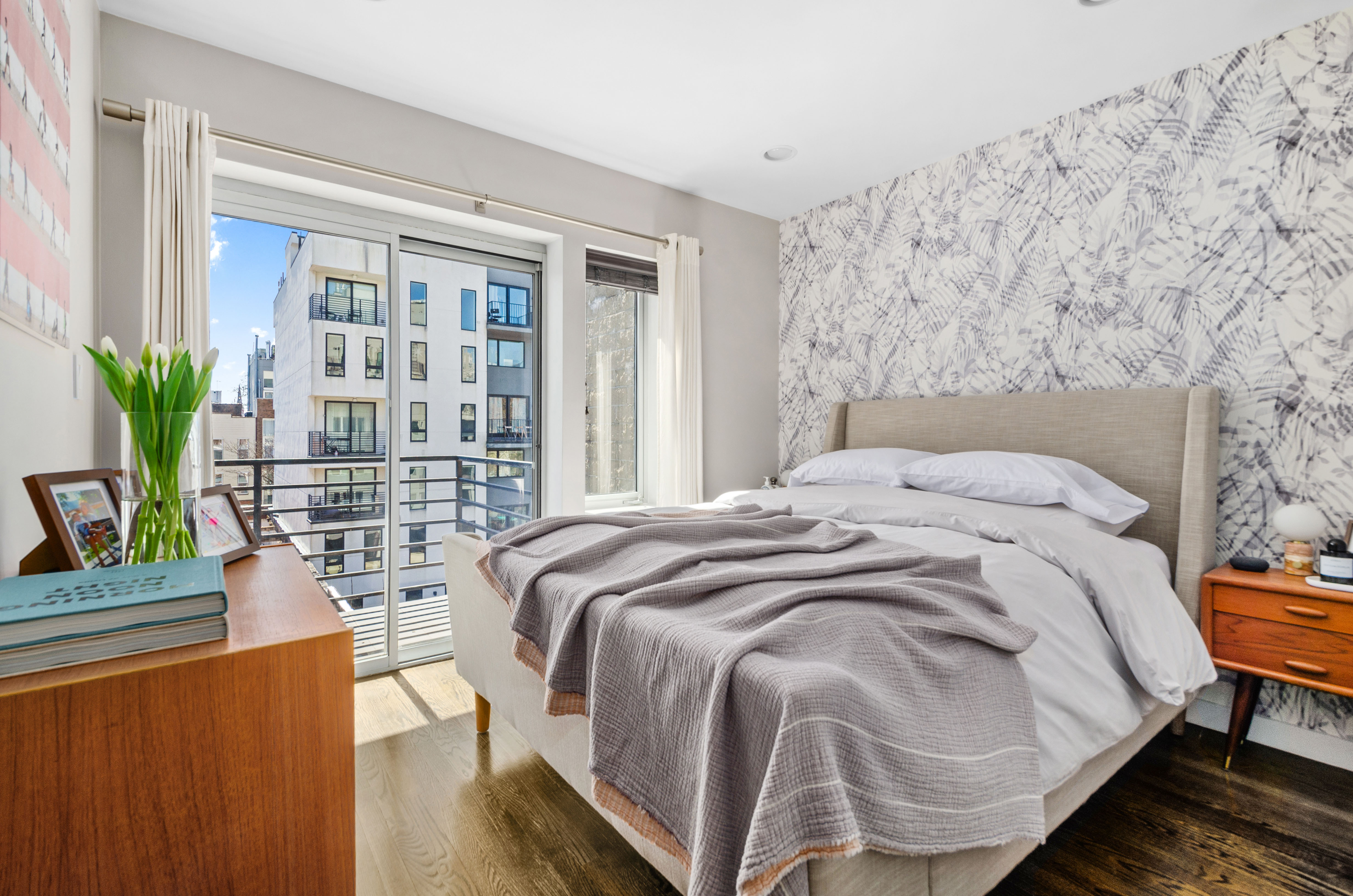 48 Box Street, Unit 5 Brooklyn, NY 11222 - Photo 5 of 10 a bedroom with a bed and a potted plant