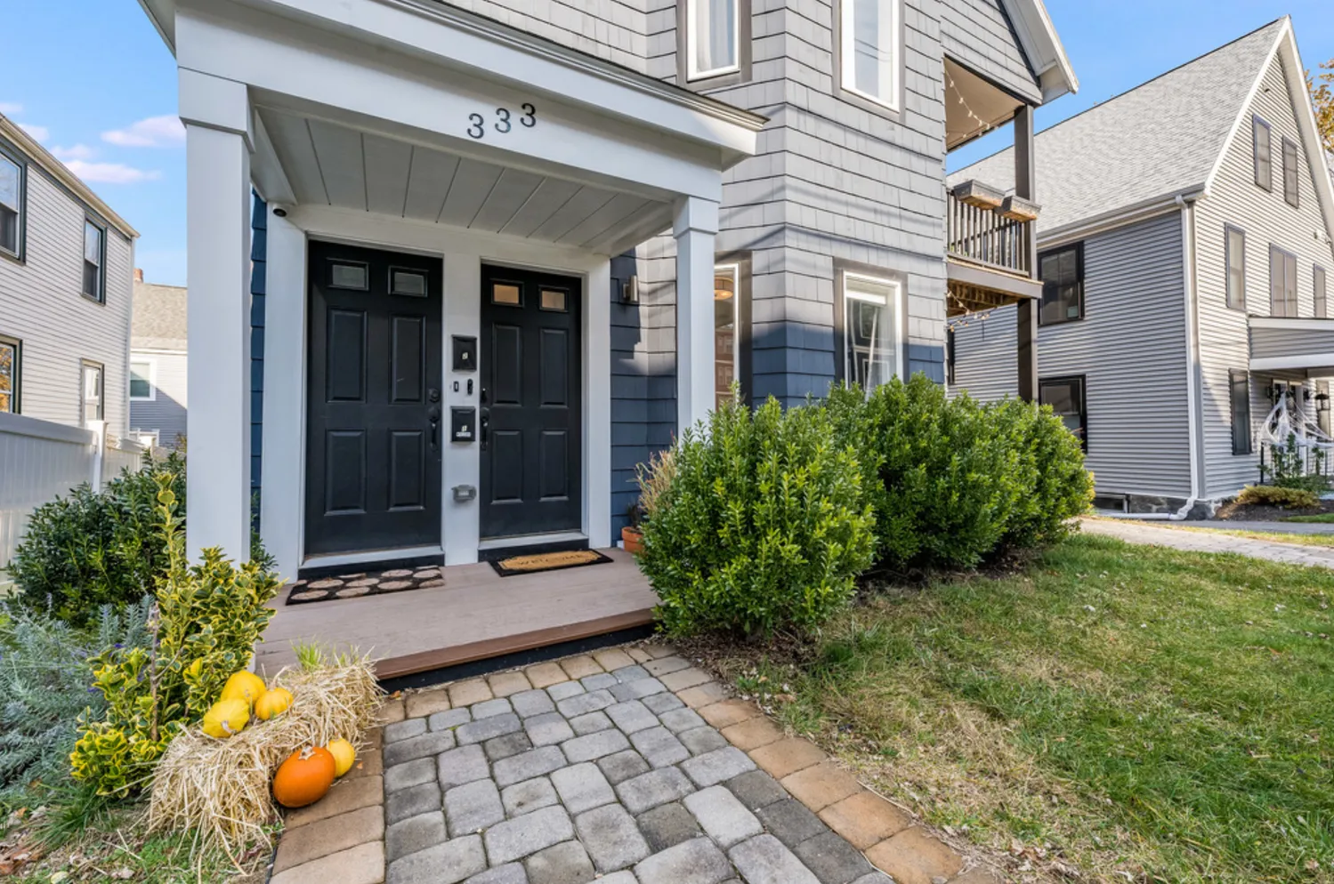 a view of a brick house with potted plants
