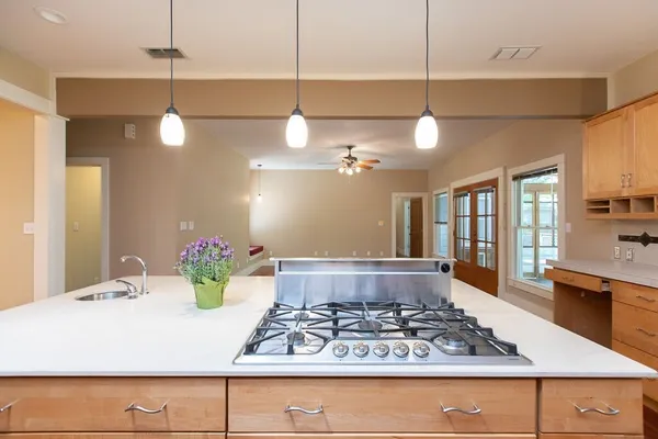 a large kitchen island with a chandelier