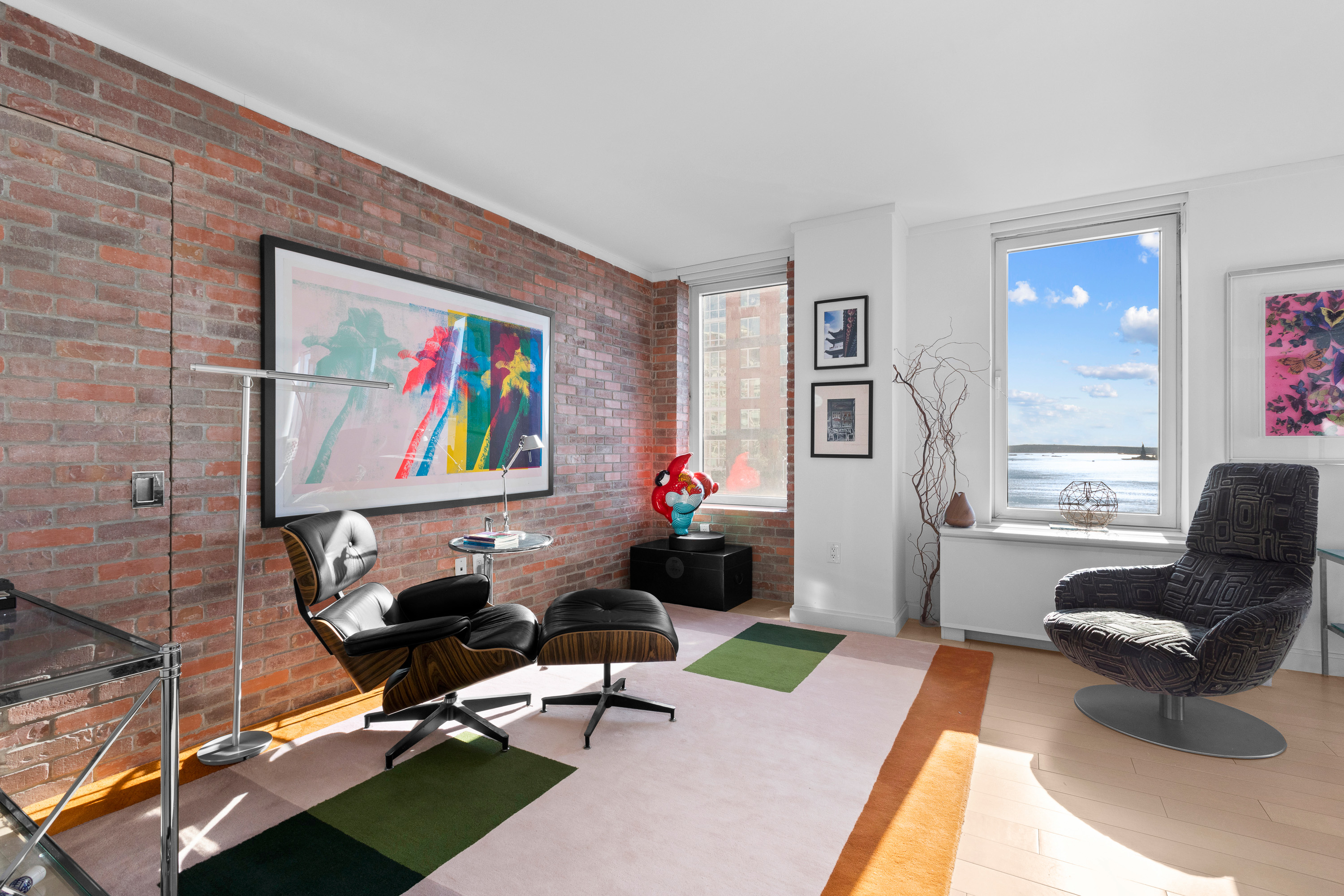 212 Warren Street, Unit 20A Manhattan, NY 10282 - Photo 6 of 23 a living room with furniture and a rug