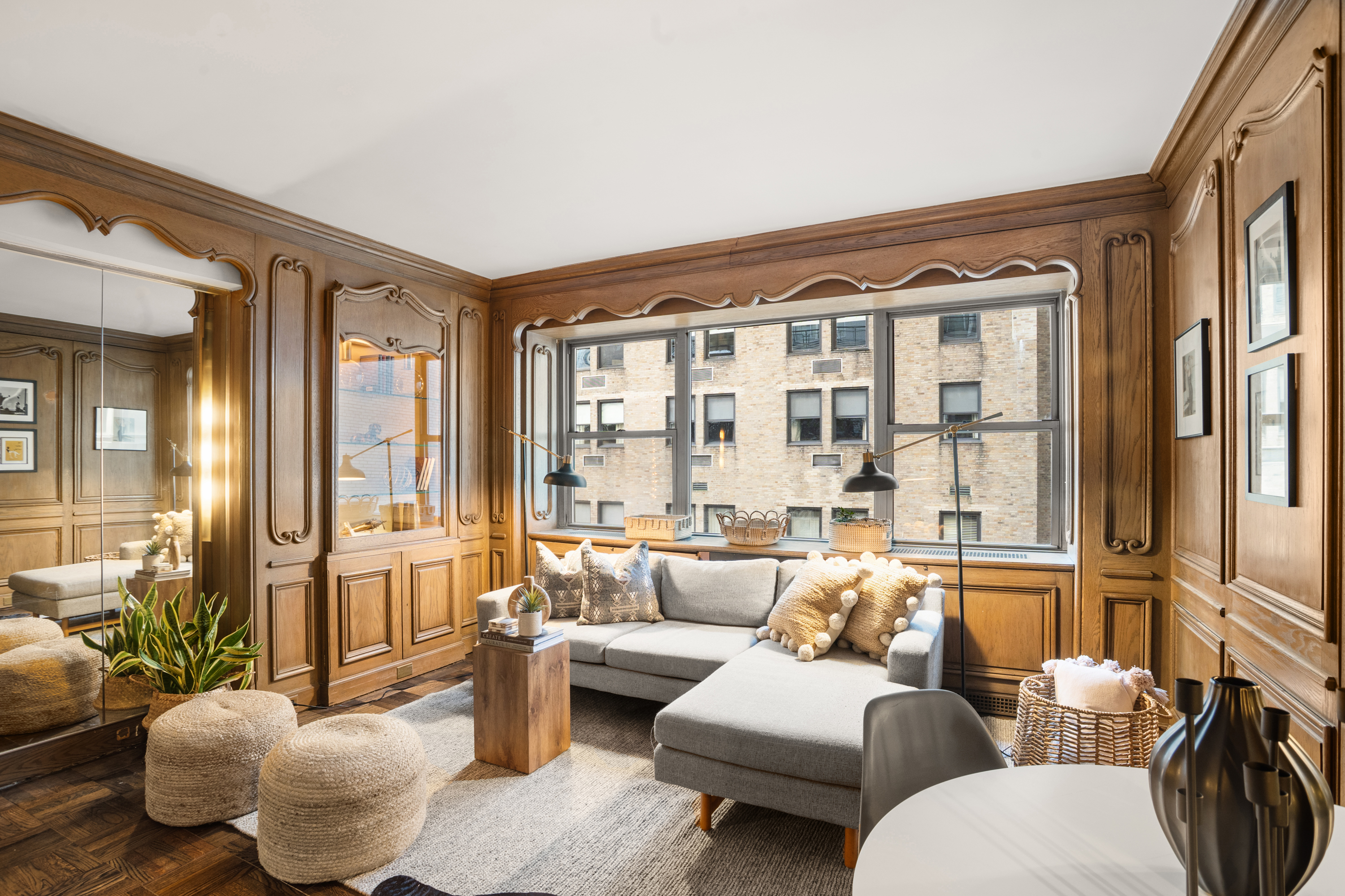 110 East 57th Street, Unit 16B Manhattan, NY 10022 - Photo 7 of 15 a living room with furniture and a large window