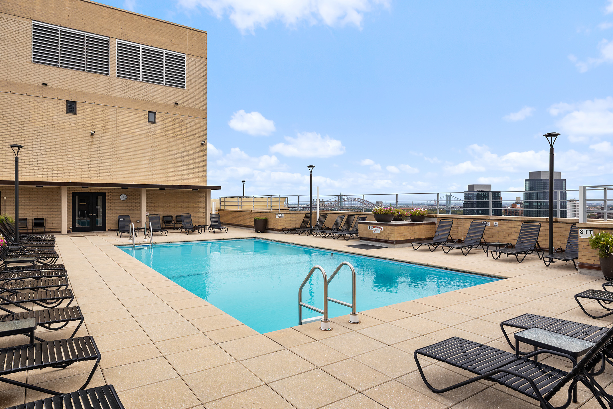 180 East End Avenue, Unit 1C Manhattan, NY 10128 - Photo 18 of 19 a swimming pool with outdoor seating and a projector