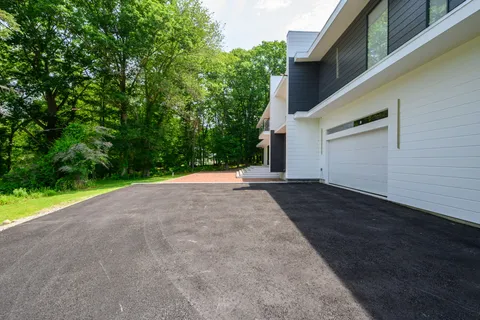 a view of a house with a yard and garage