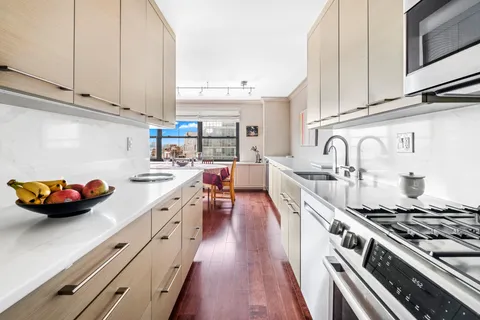 a kitchen with stainless steel appliances granite countertop a stove and a sink
