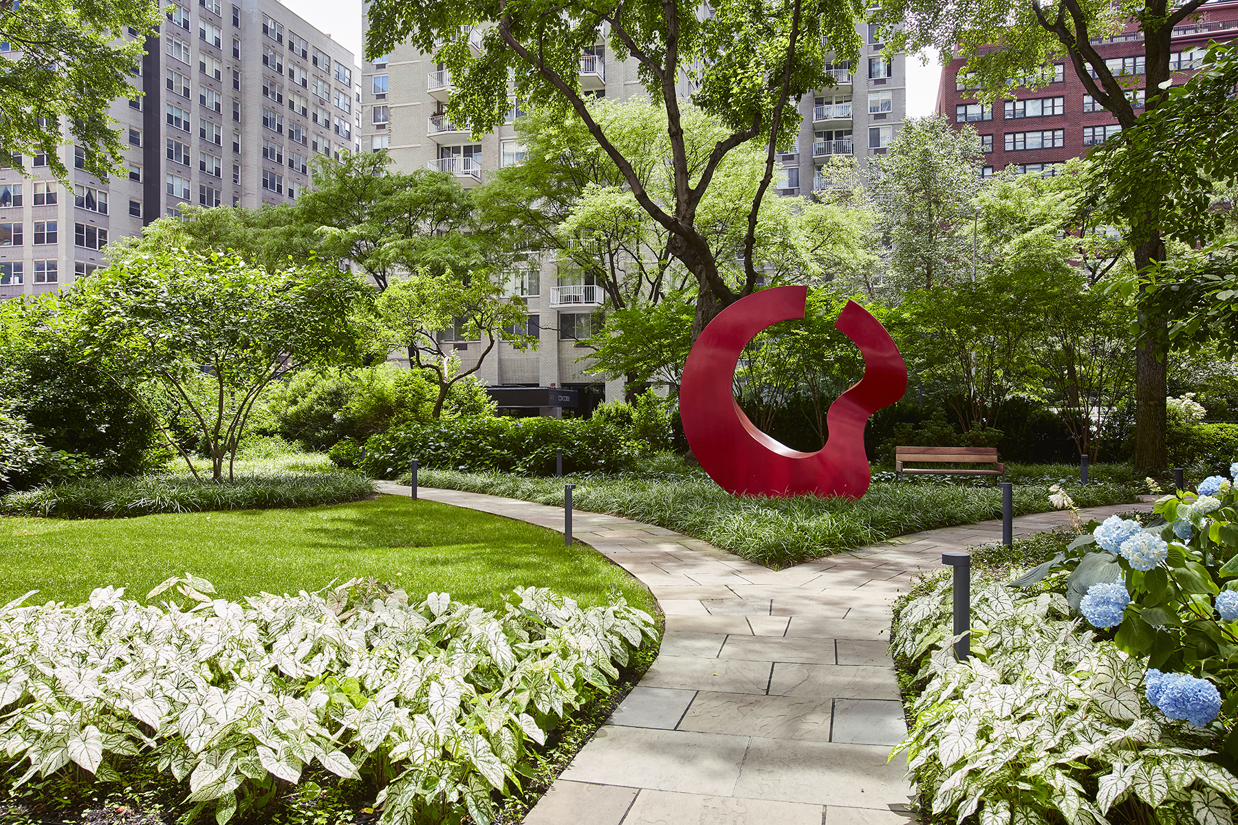 200 East 66th Street, Unit D1004 Manhattan, NY 10065 - Photo 3 of 6 a view of a garden with plants and large trees