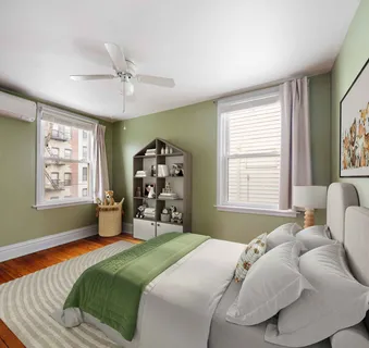 a bedroom with a bed next to a window and a chandelier