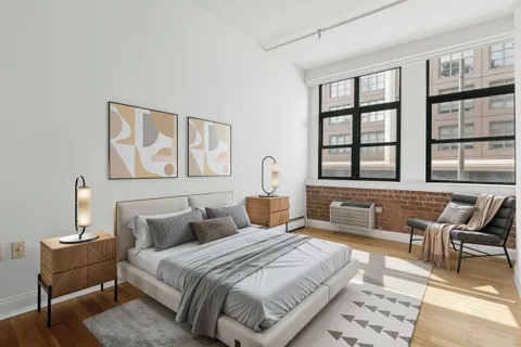 a spacious bedroom with a bed and a couch