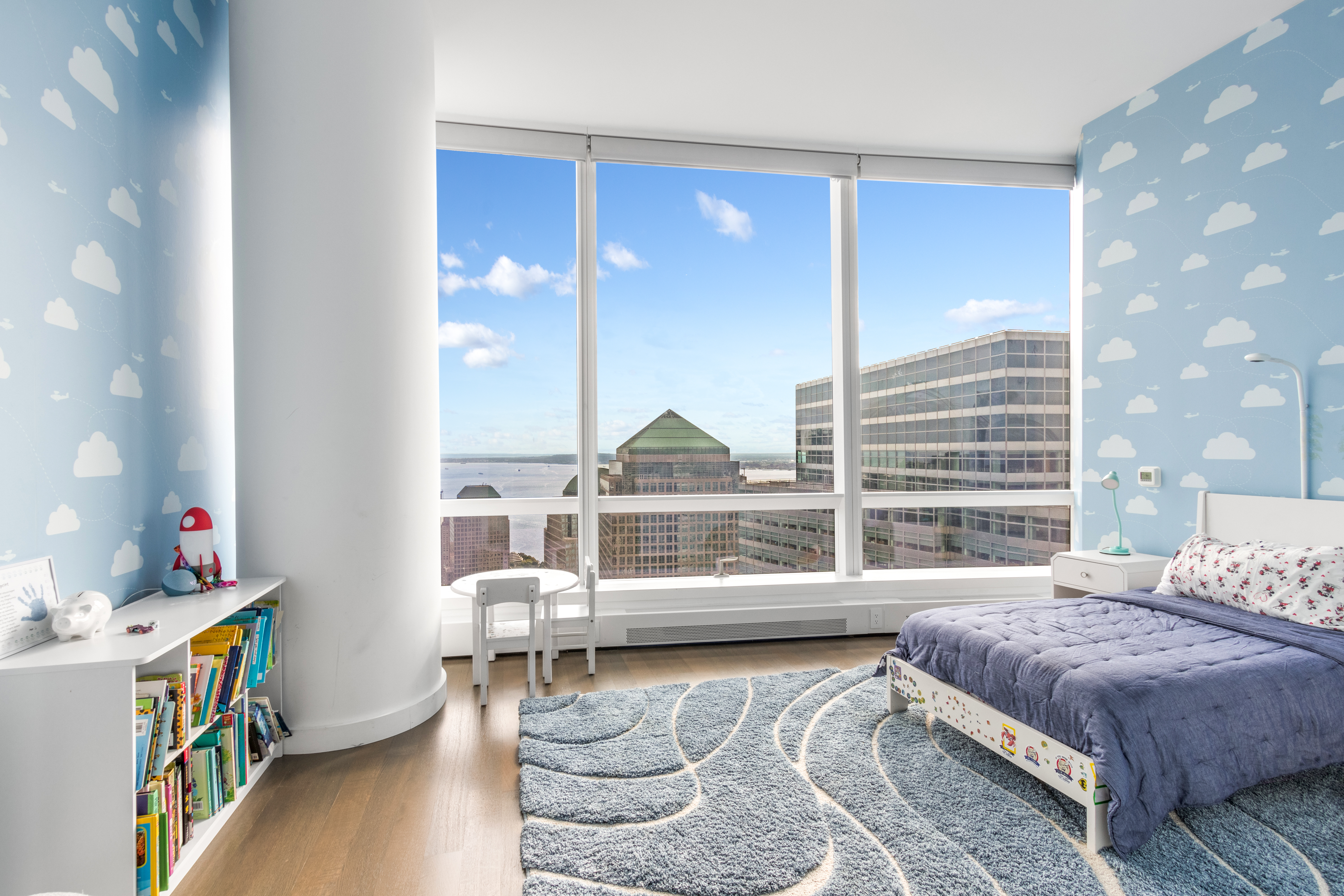 111 Murray Street, Unit 61W Manhattan, NY 10007 - Photo 22 of 35 a bedroom with a bed a large window and book shelf