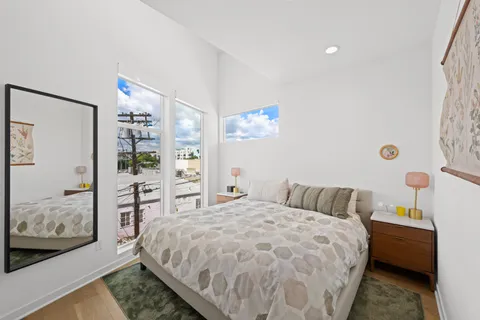 a bedroom with a large bed and a view of bedroom