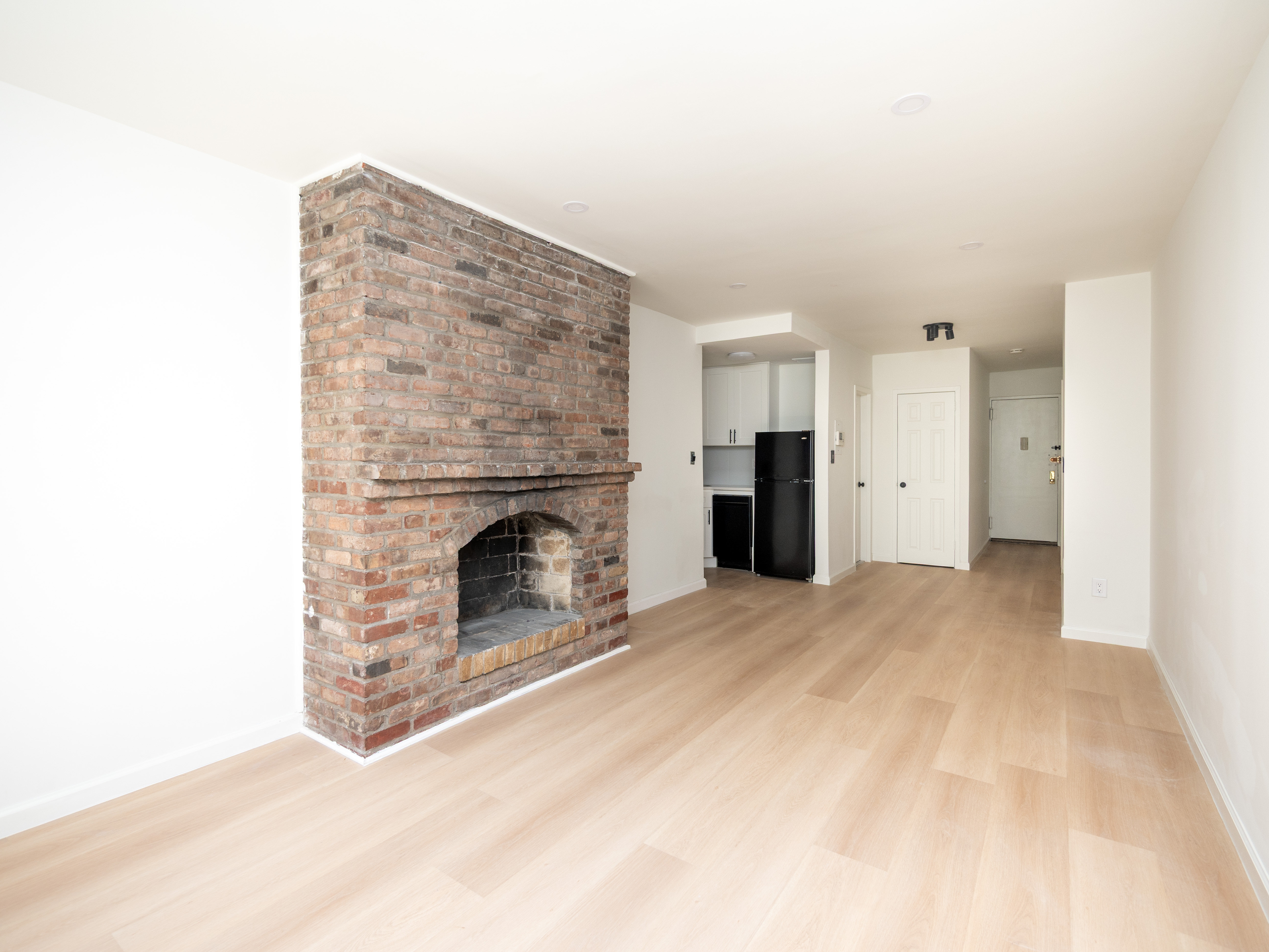 314 West 56th Street, Unit 4E Manhattan, NY 10019 - Photo 2 of 7 a view of a livingroom with a fireplace