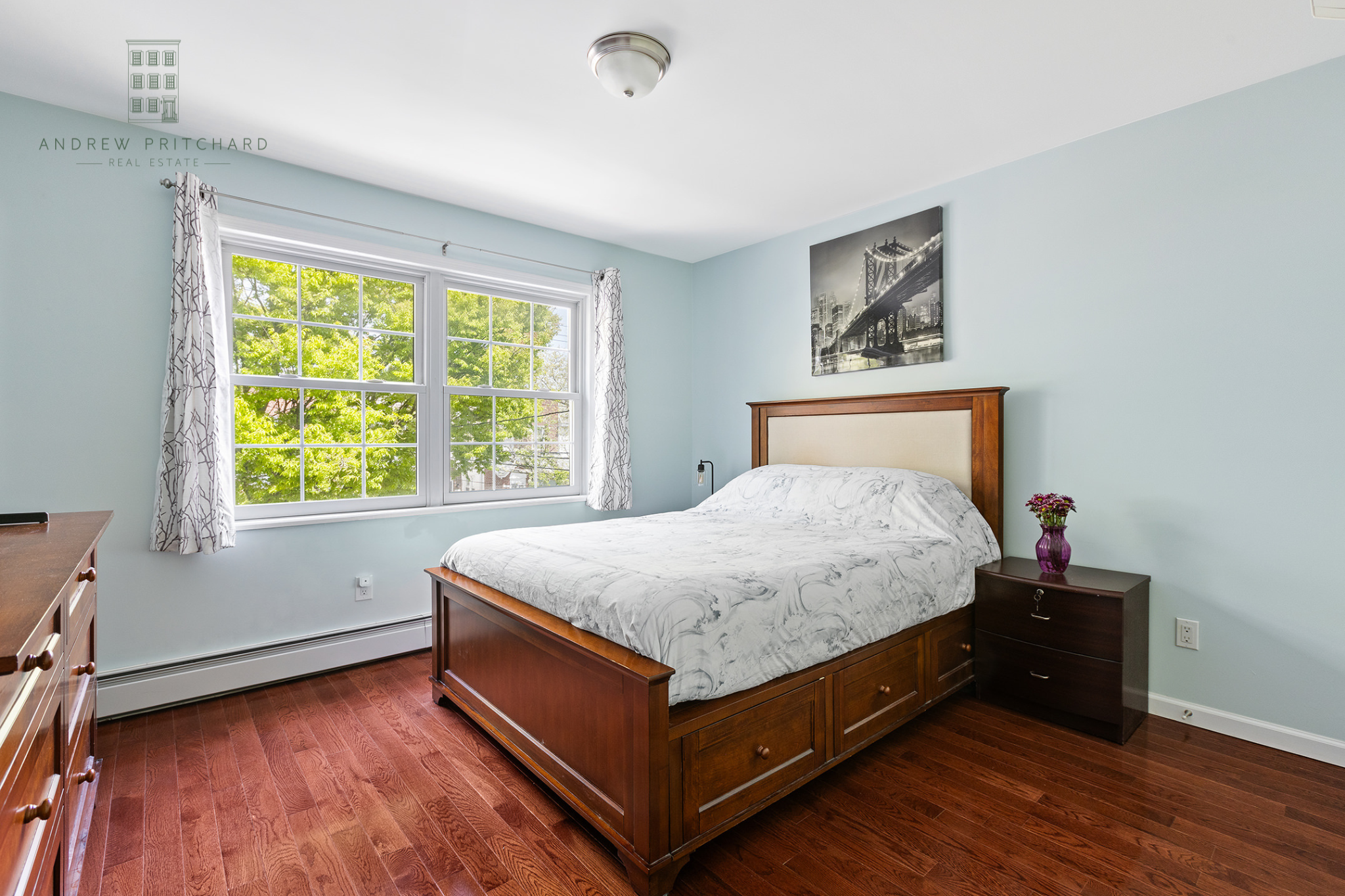 1140 78th Street Brooklyn, NY 11228 - Photo 9 of 12 a bed sitting in a bedroom next to a window