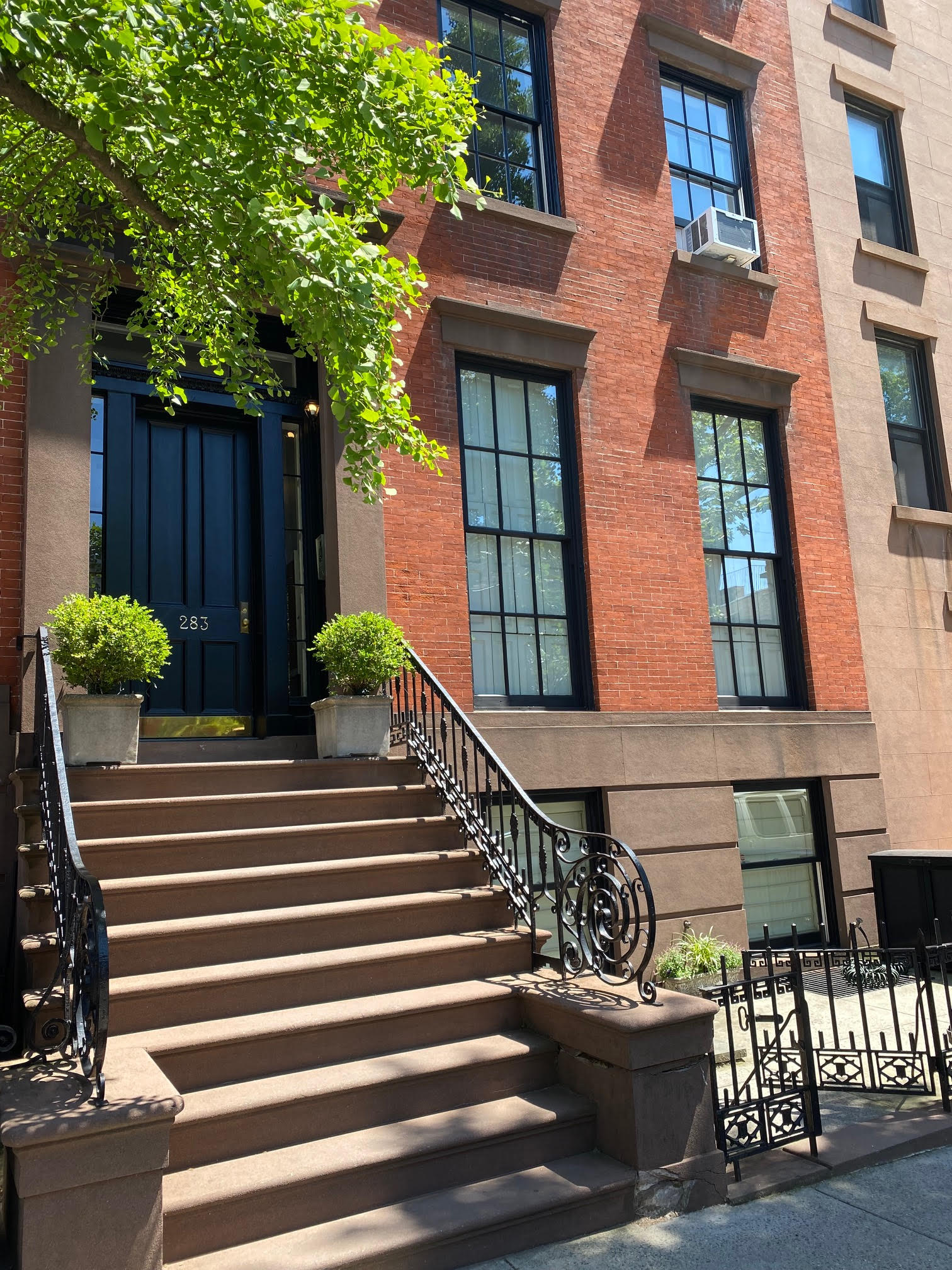 283 Hicks Street, Unit 4B Brooklyn, NY 11201 - Photo 13 of 15 a view of a house with large windows and flower plants