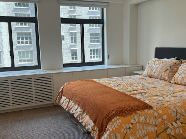124 East 79th Street, Unit 7D Manhattan, NY 10075 - Photo 9 of 25 a bedroom with a bed and window