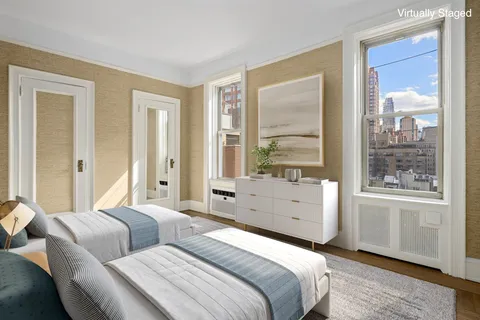 a spacious bedroom with a bed and a large window