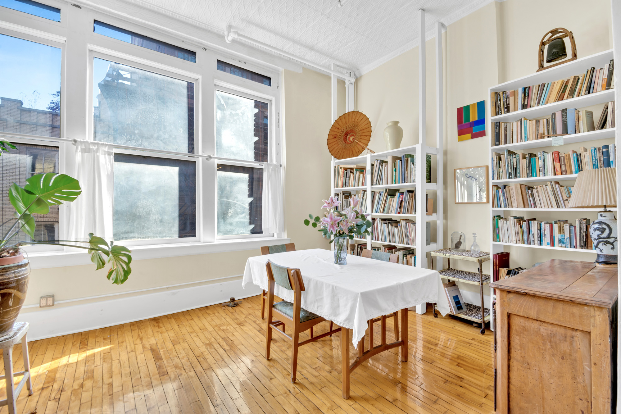 69 Wooster Street, Unit 3 Manhattan, NY 10012 - Photo 7 of 22 a view of a dining room with furniture window and wooden floor