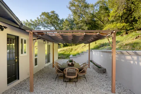 a backyard of a house with table and chairs