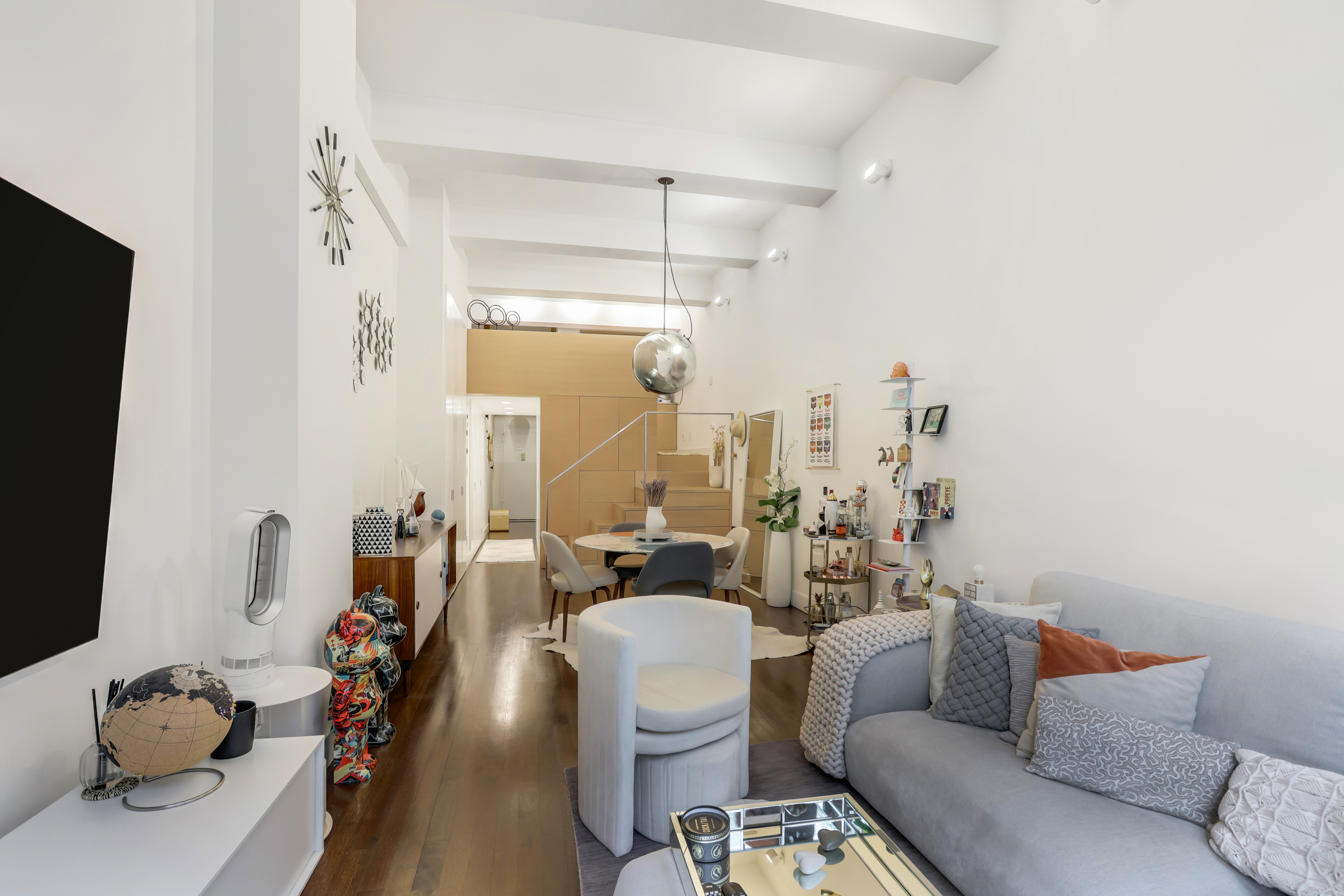 310 East 46th Street, Unit 10S Manhattan, NY 10017 - Photo 3 of 10 a living room with furniture and a flat screen tv