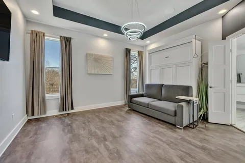 a living room with furniture and a chandelier