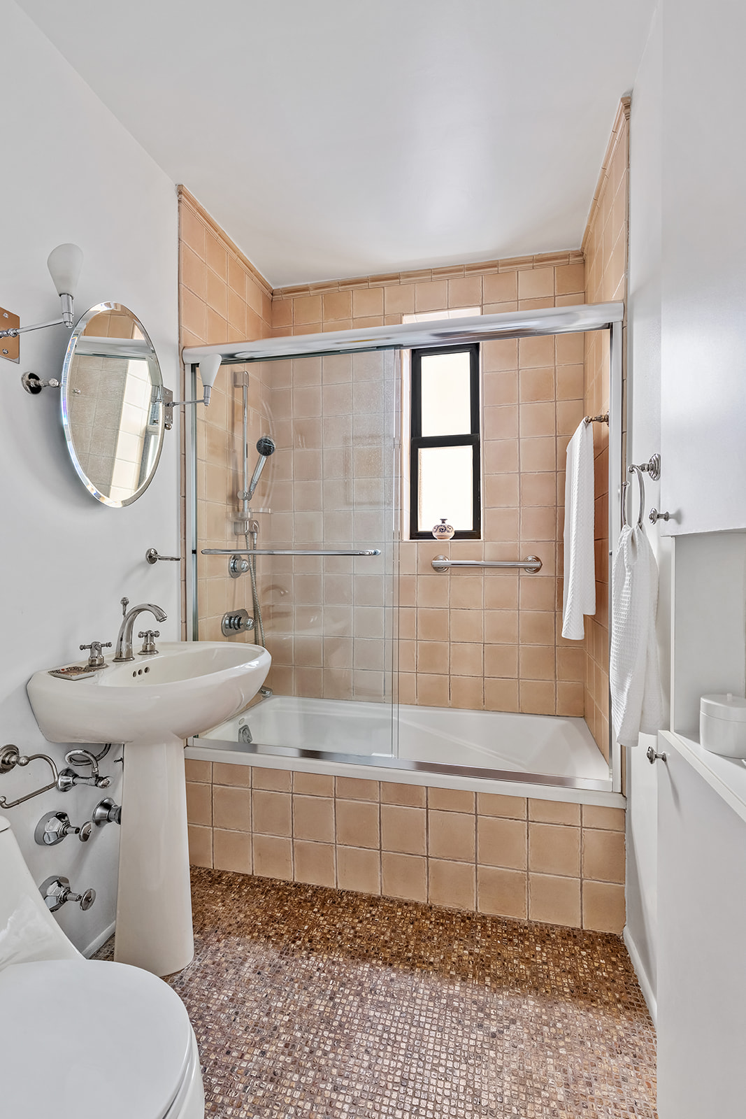 330 East 80th Street, Unit 5O Manhattan, NY 10075 - Photo 6 of 7 a bathroom with a sink toilet and shower
