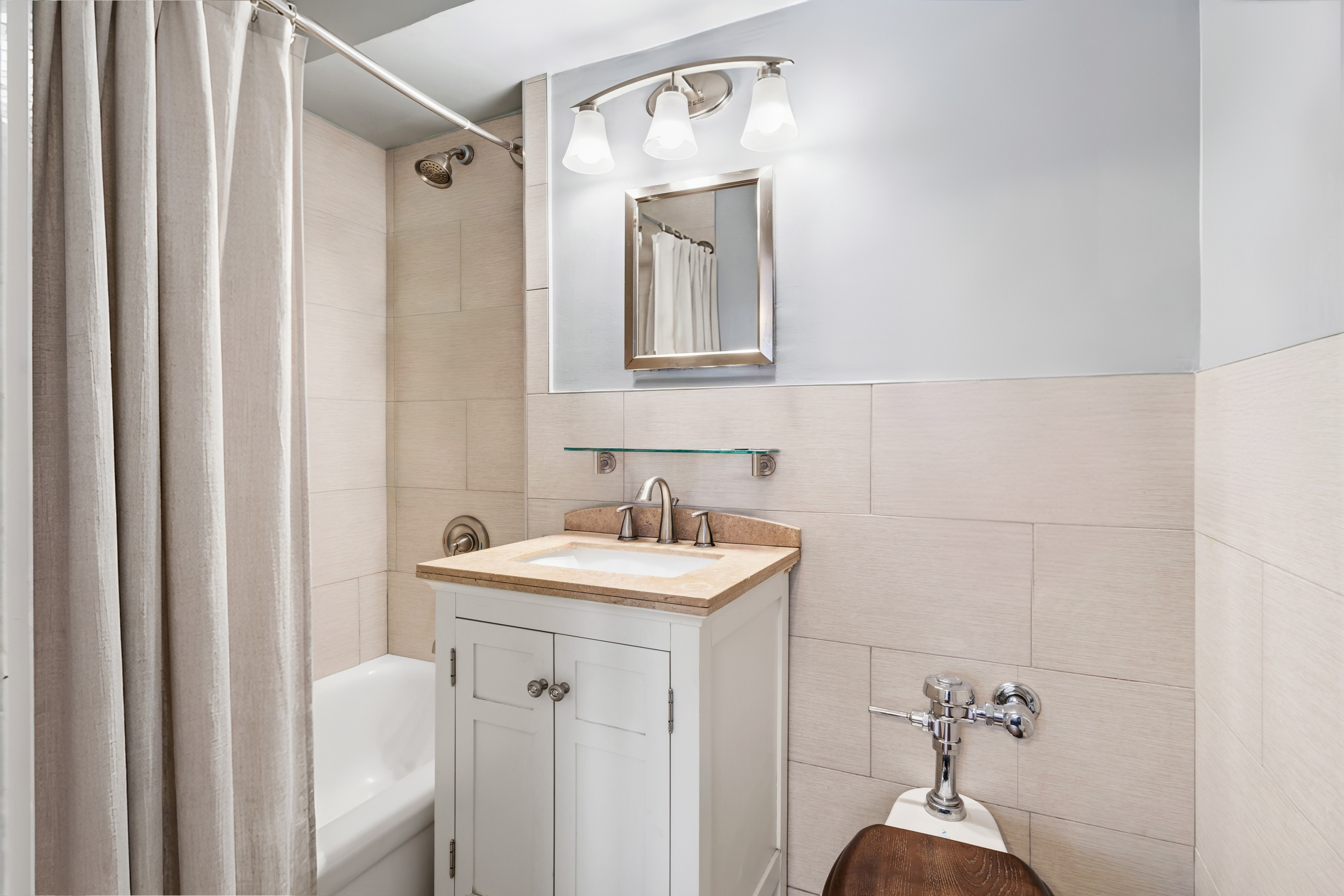 166 East 35th Street, Unit 5C Manhattan, NY 10016 - Photo 5 of 16 a bathroom with a sink vanity and a mirror
