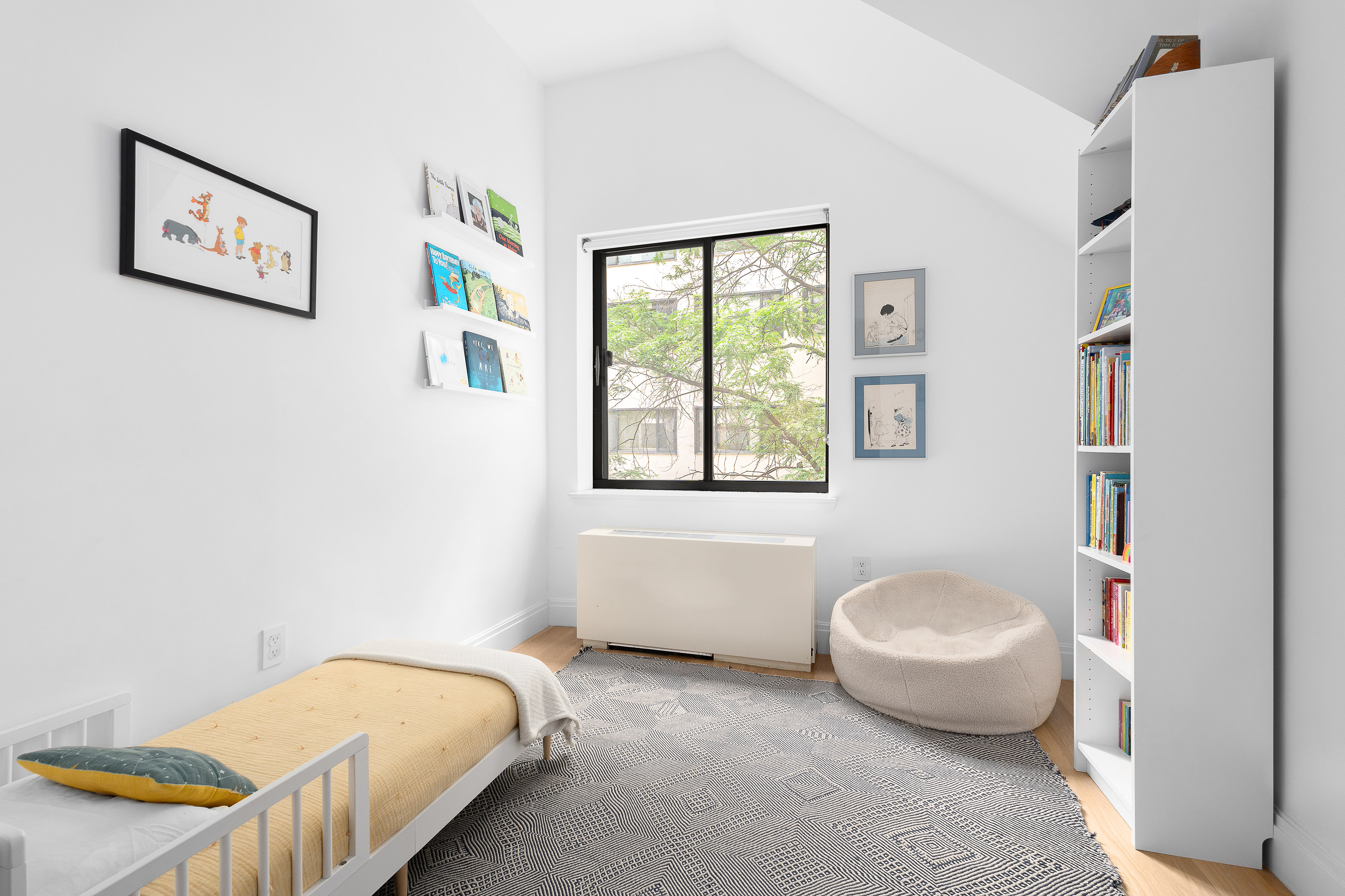 77 Bleecker Street, Unit 123E Manhattan, NY 10012 - Photo 12 of 13 a bedroom with a bed and a window