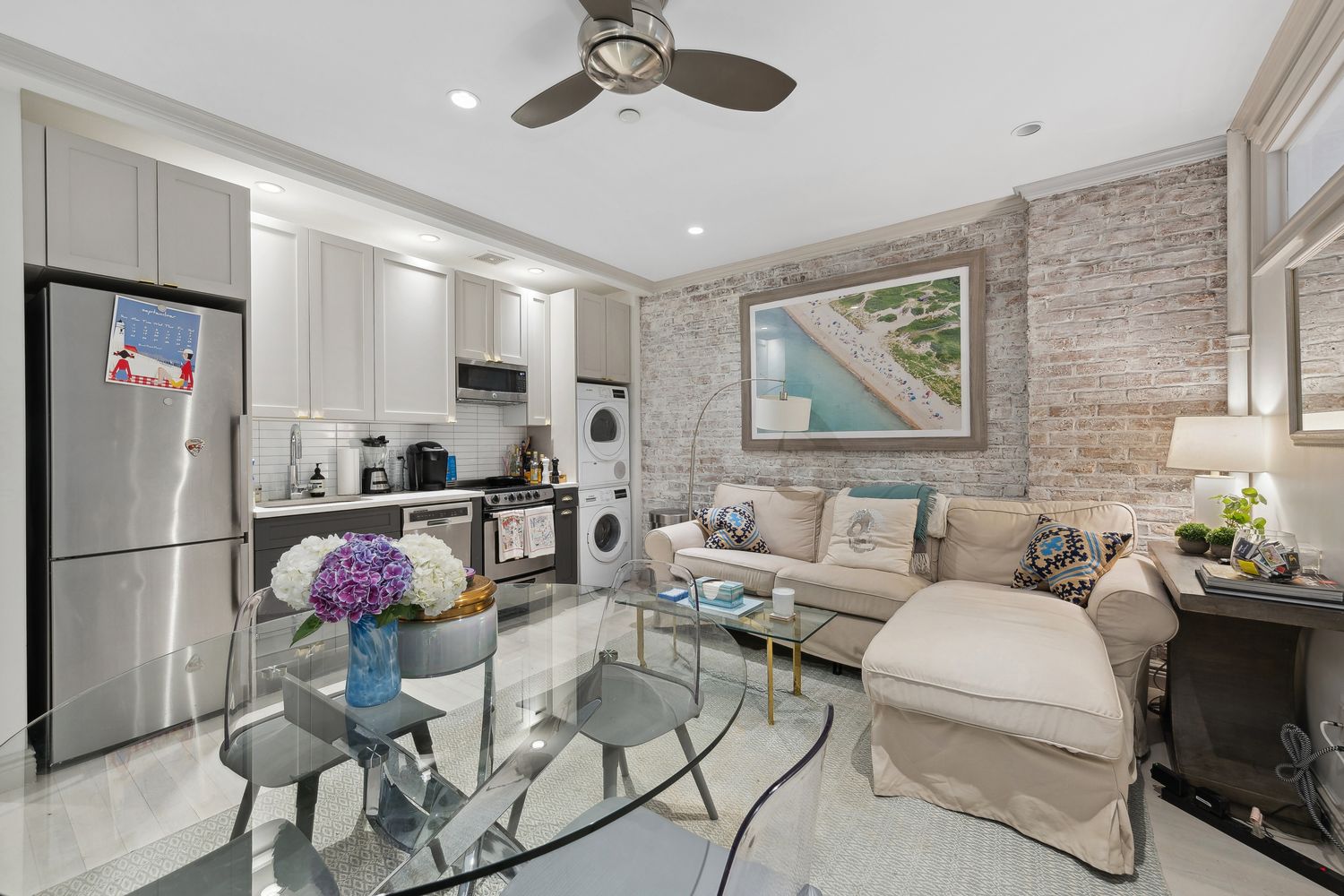a living room with furniture and kitchen view