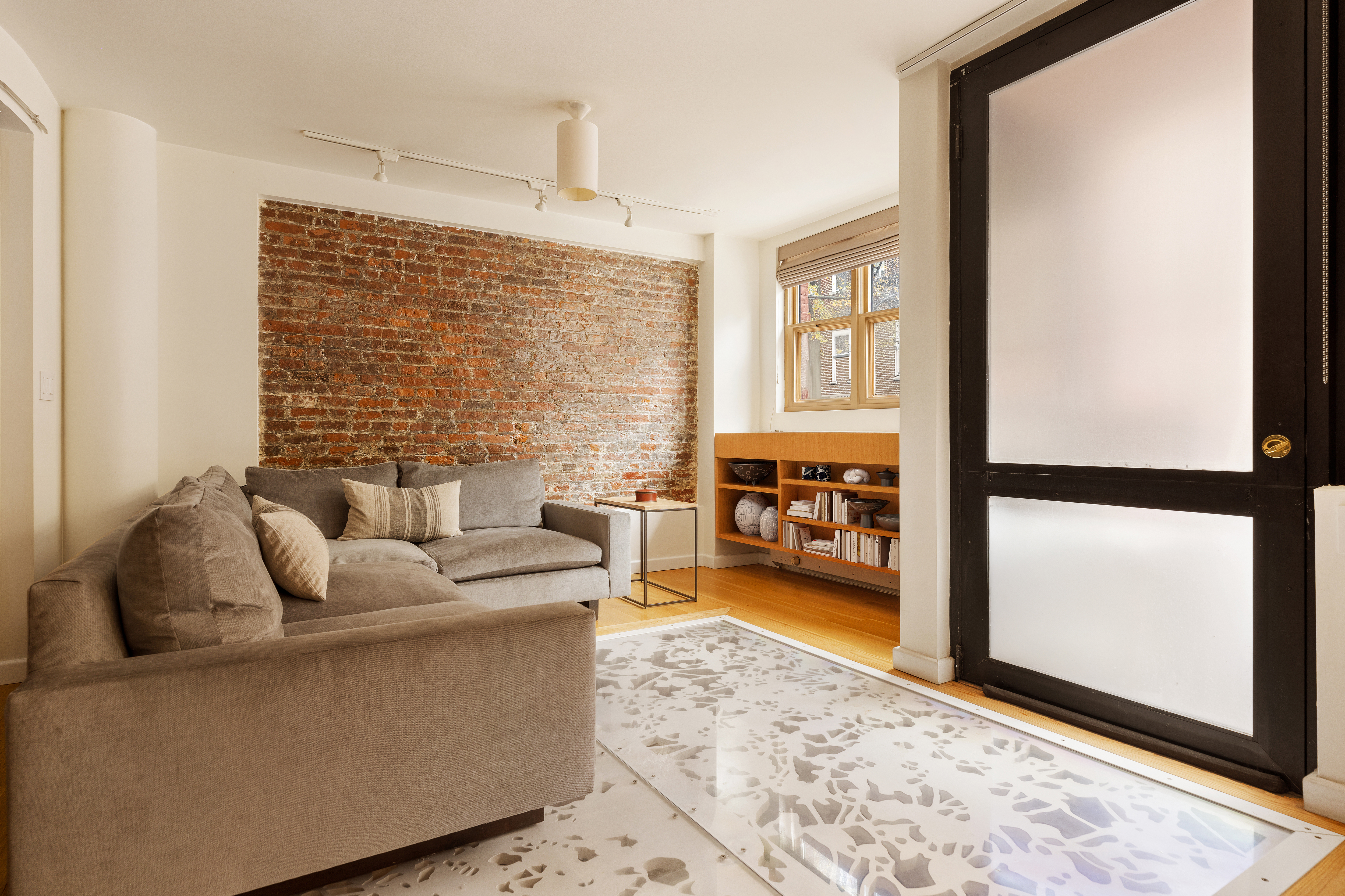 357 West 12th Street, Unit 1E Manhattan, NY 10014 - Photo 3 of 12 a living room with furniture and a flat screen tv