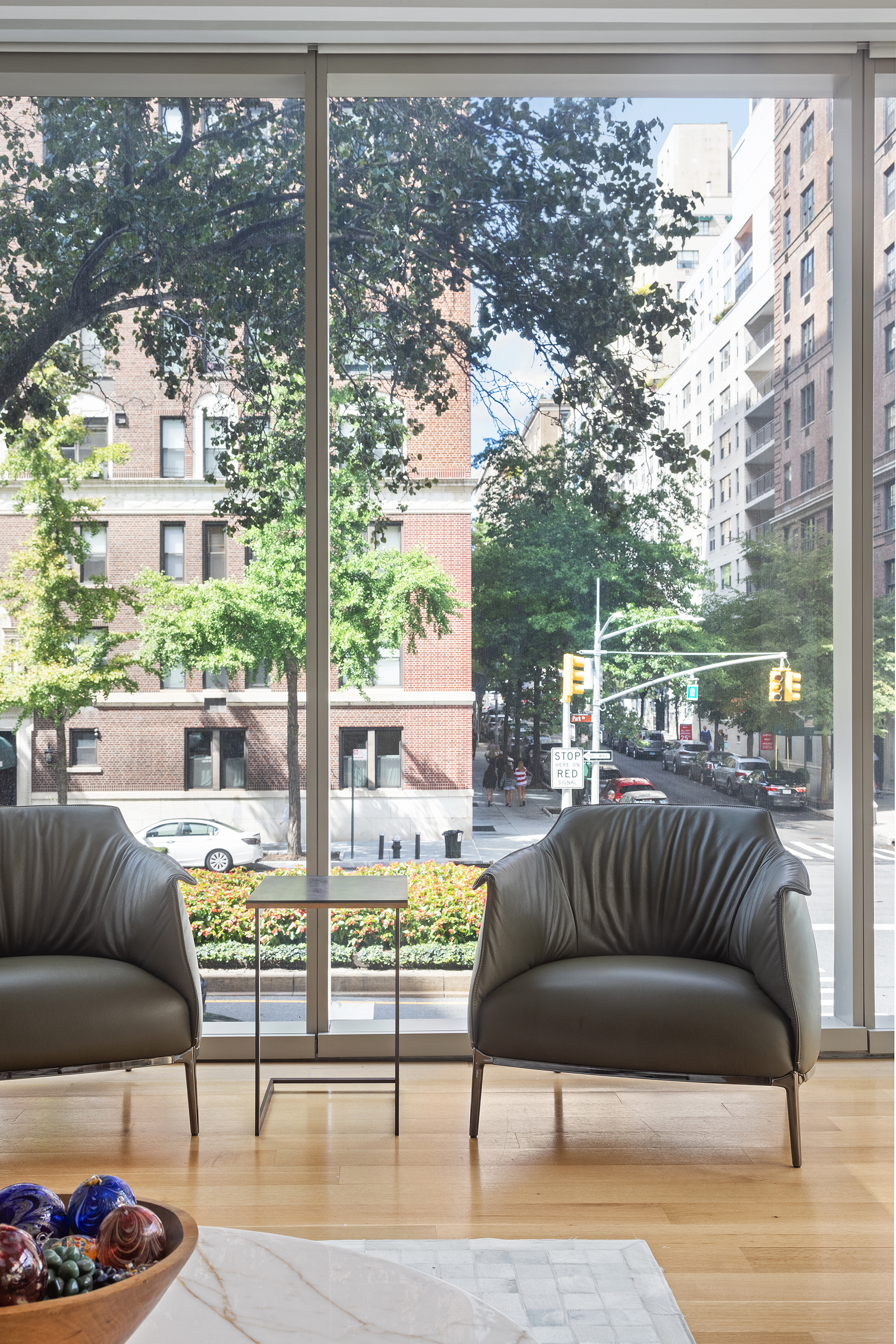 1055 Park Avenue, Unit 1 Manhattan, NY 10028 - Photo 3 of 19 a living room with furniture and a floor to ceiling window