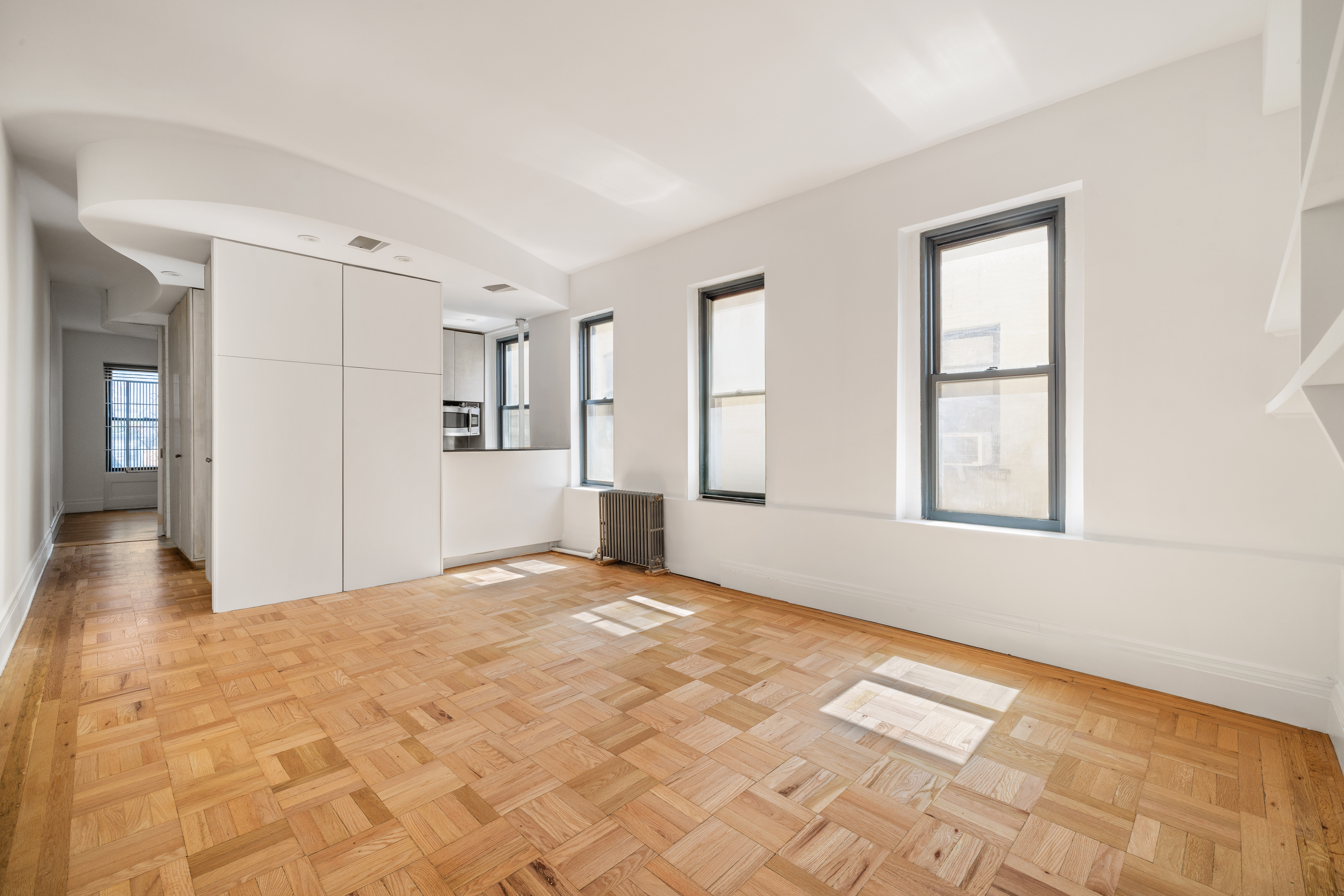 327 West 83rd Street, Unit 6B Manhattan, NY 10024 - Photo 2 of 13 a view of an empty room with window and wooden floor