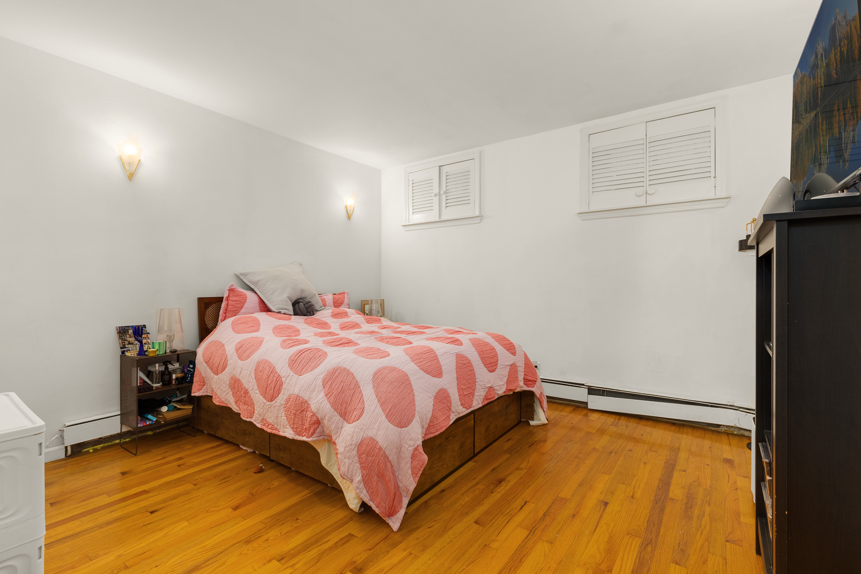 502 West 141st Street, Unit 1A Manhattan, NY 10031 - Photo 5 of 8 a bedroom with a bed and flat screen tv