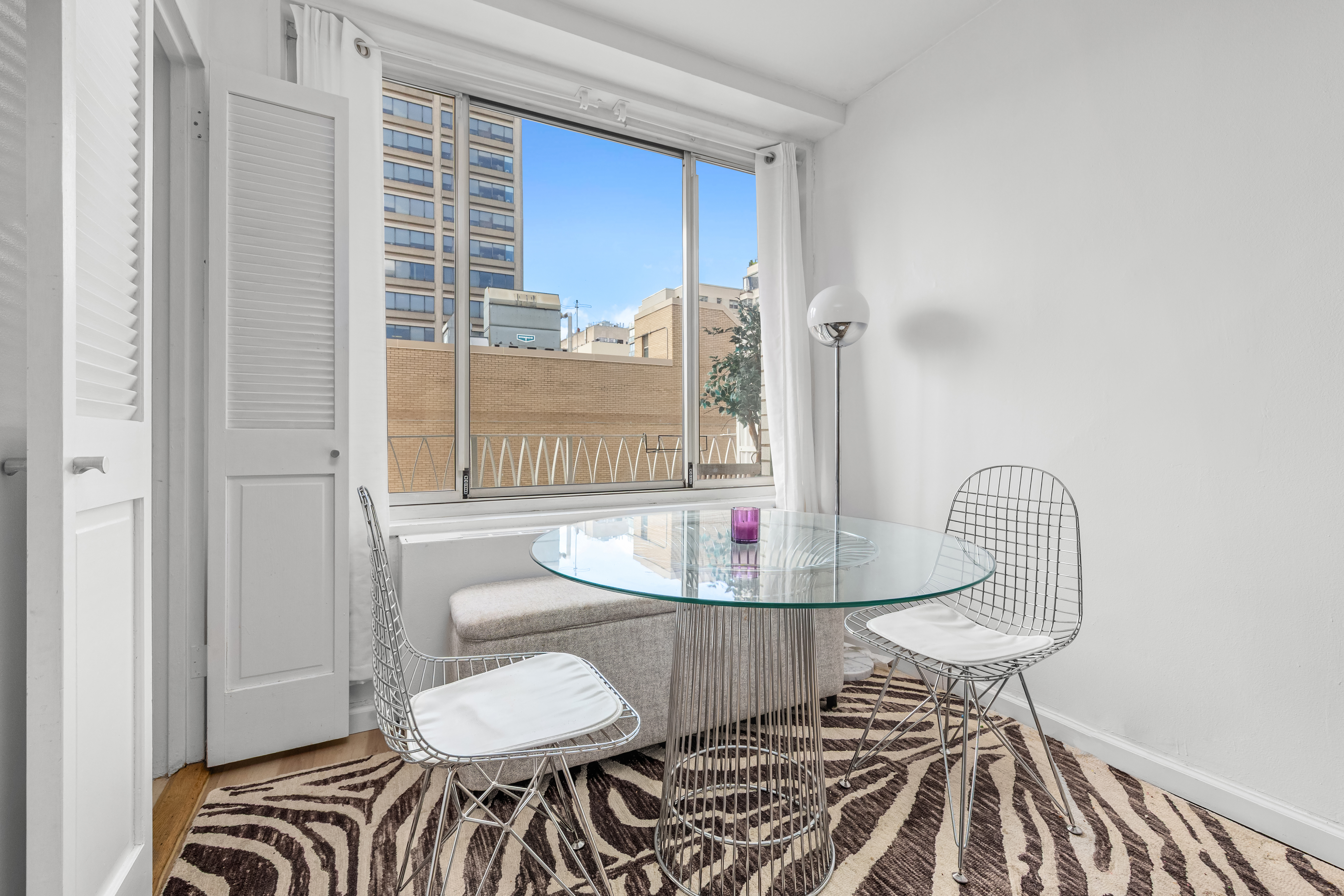 1160 3rd Avenue, Unit 12C Manhattan, NY 10065 - Photo 3 of 6 a dining room with furniture and wooden floor
