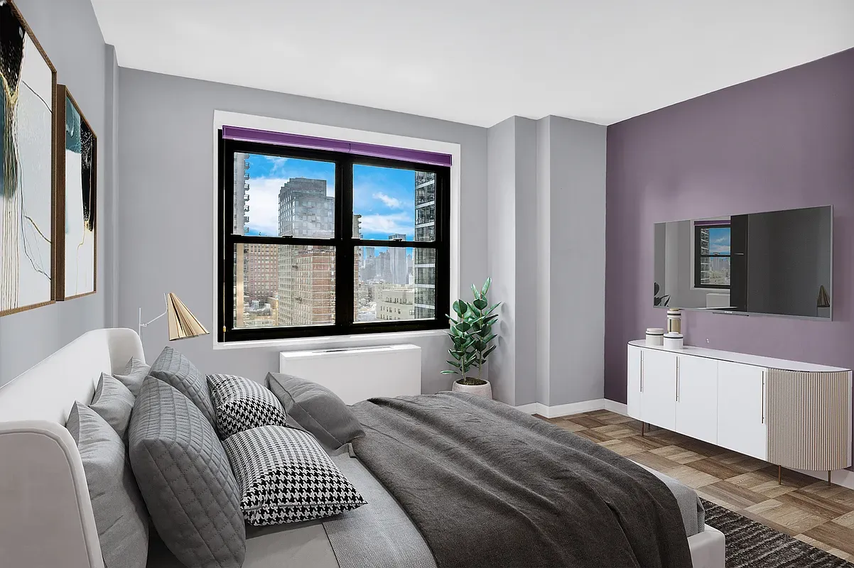 a bedroom with a large bed and a large window