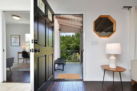 a dining room with wooden floor a glass table and chairs