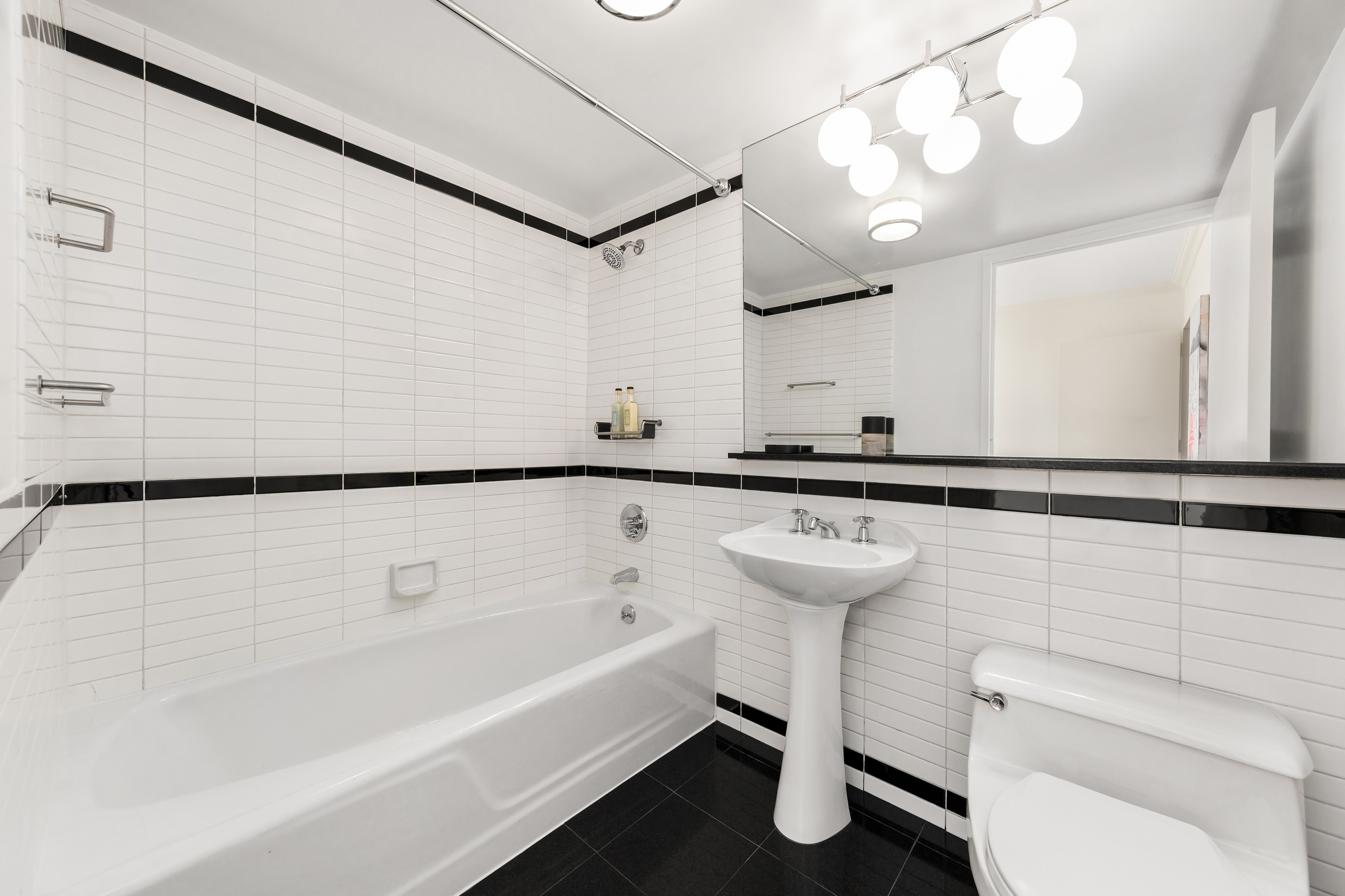 360 East 88th Street, Unit 31C Manhattan, NY 10128 - Photo 16 of 24 a bathroom with a sink a toilet and a bathtub