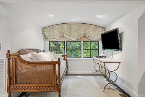 a bathroom with a granite countertop toilet a sink and a mirror