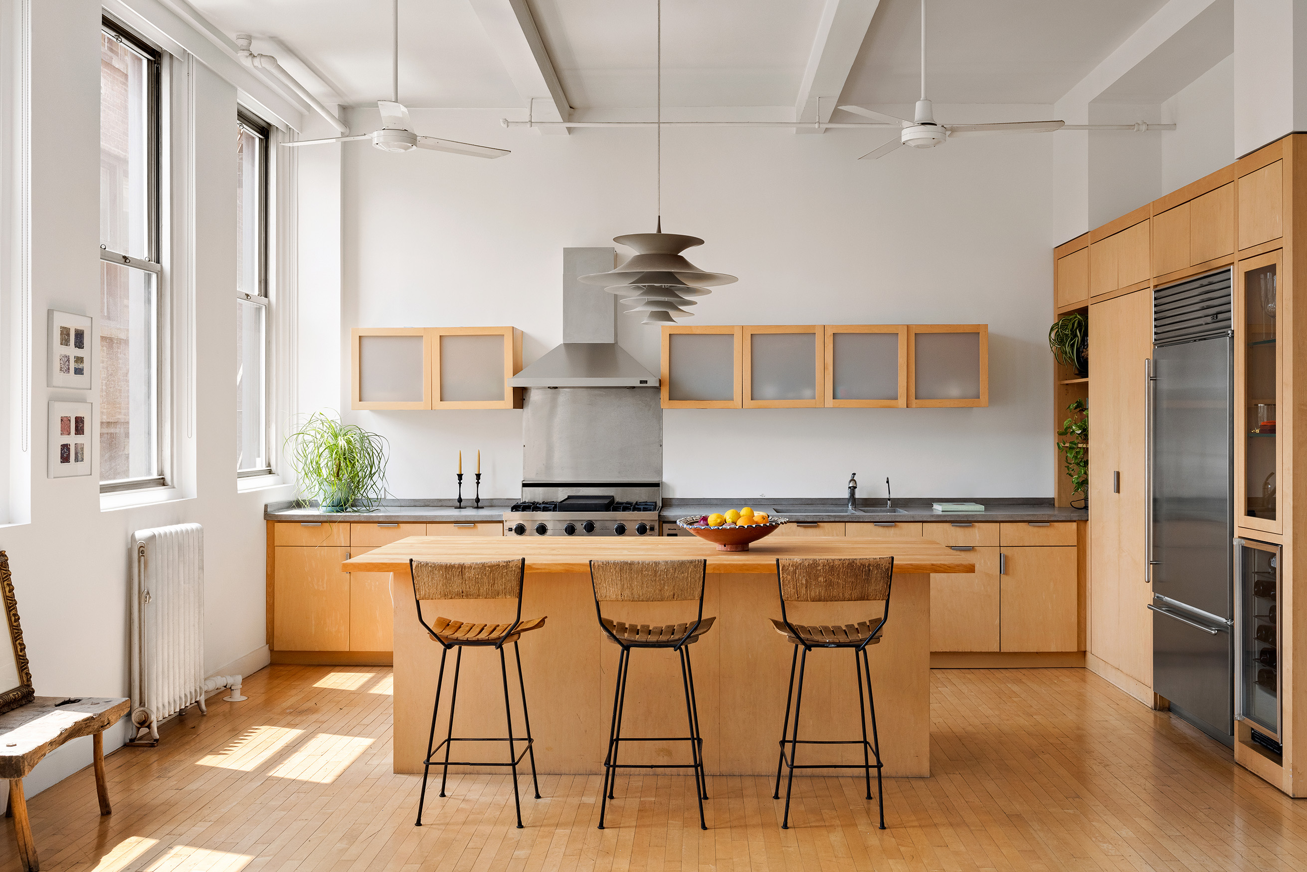 32 West 20th Street, Unit 9B Manhattan, NY 10011 - Photo 3 of 16 a kitchen with stainless steel appliances granite countertop a stove a refrigerator a oven a sink with a dining table and chairs