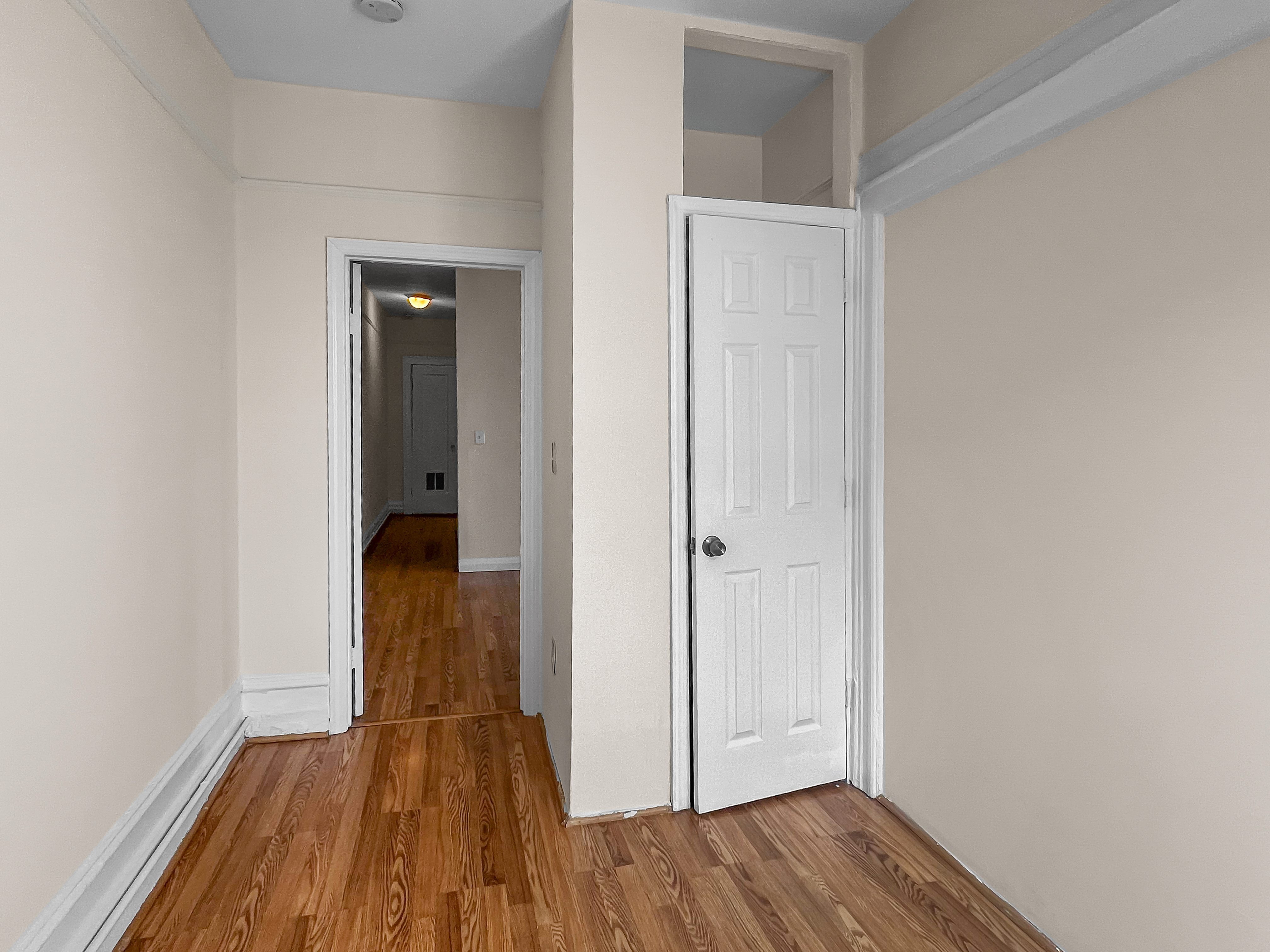 35-19 Broadway, Unit 3 Queens, NY 11106 - Photo 8 of 11 a view of a room with wooden floor and a hallway