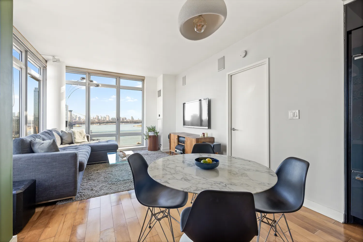 a view of a dining room with furniture window and wooden floor