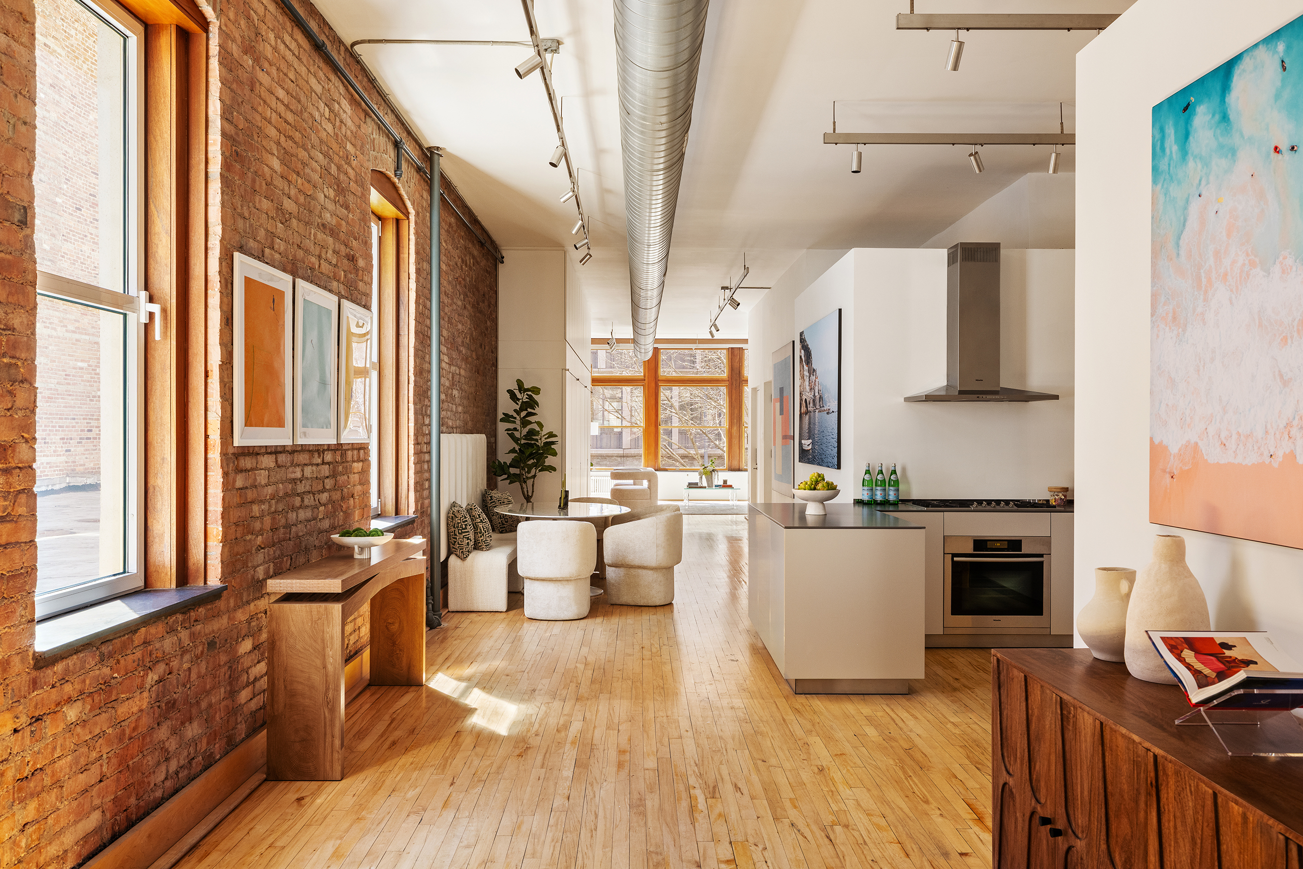 25 East 4th Street, Unit 2 Manhattan, NY 10003 - Photo 7 of 12 a kitchen with stainless steel appliances a stove top oven a sink a dining table and chairs