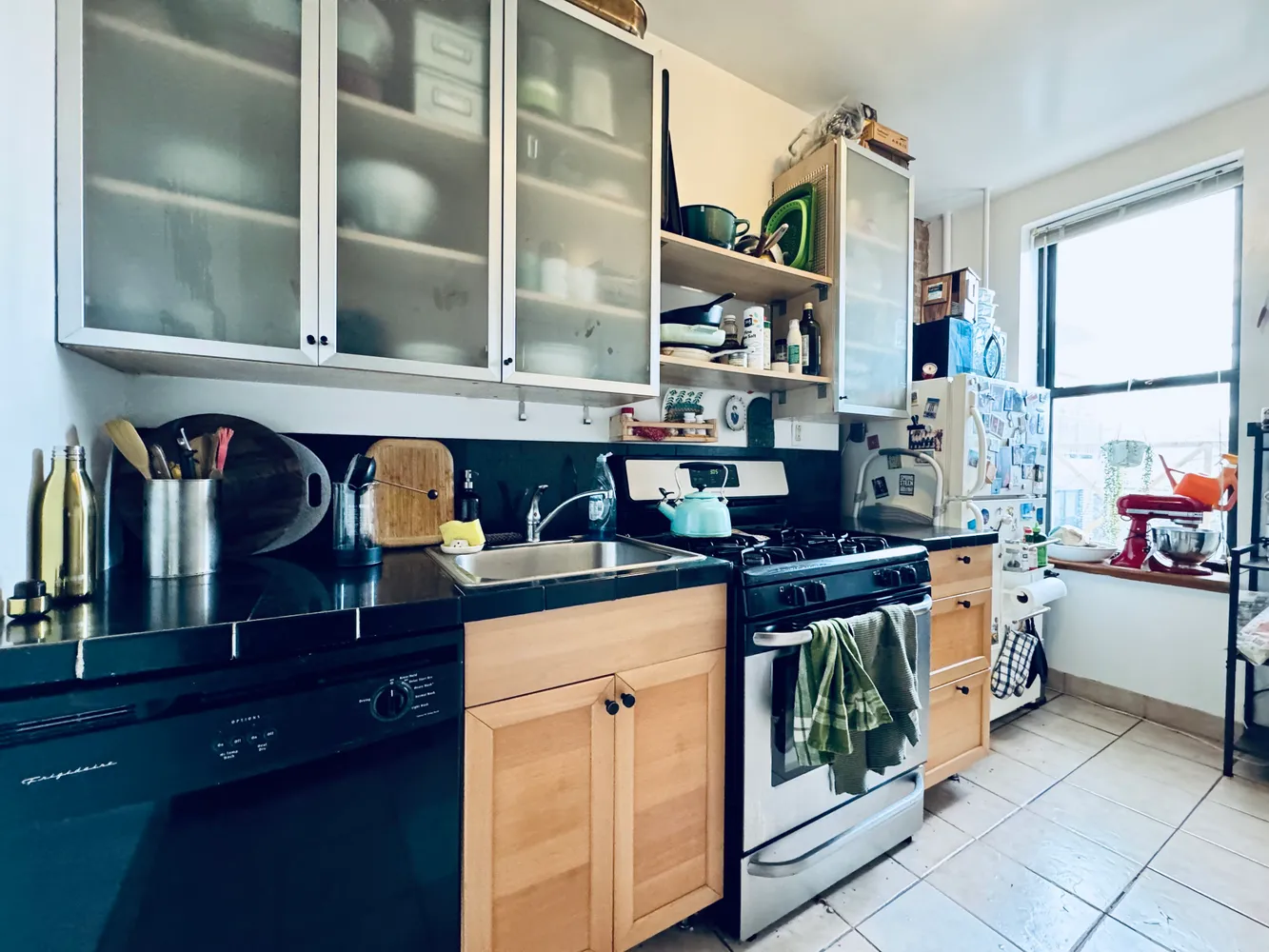 a kitchen with stainless steel appliances granite countertop a stove and cabinets