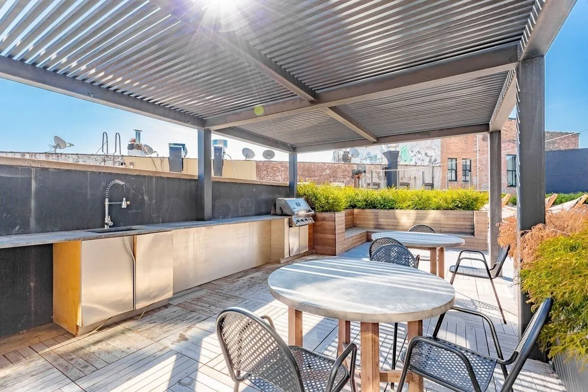 a view of a patio with a table and chairs under an umbrella