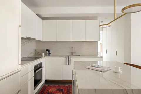 a kitchen with a sink and cabinets
