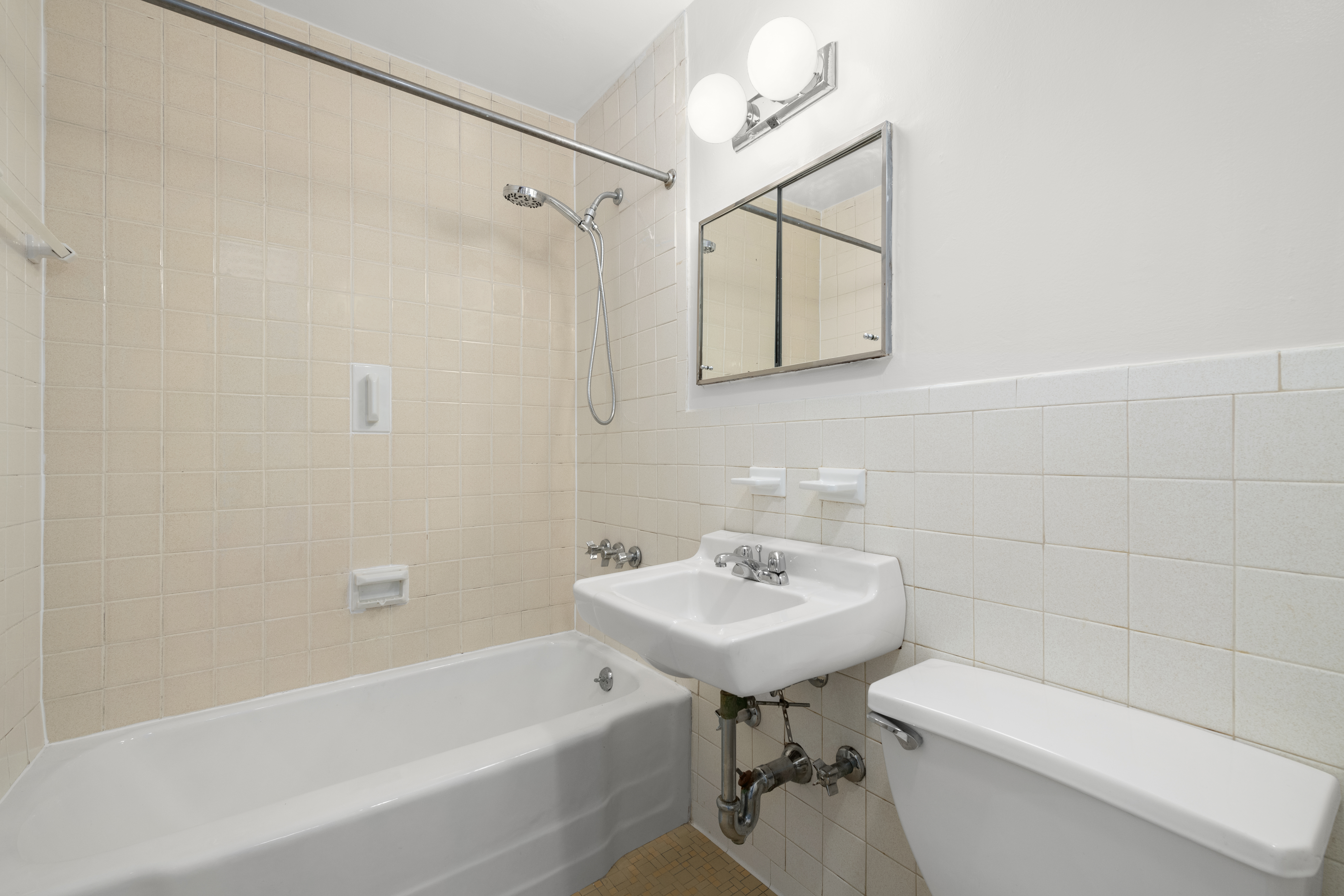 245 East 25th Street, Unit 8K Manhattan, NY 10010 - Photo 6 of 7 a bathroom with a sink a toilet and shower