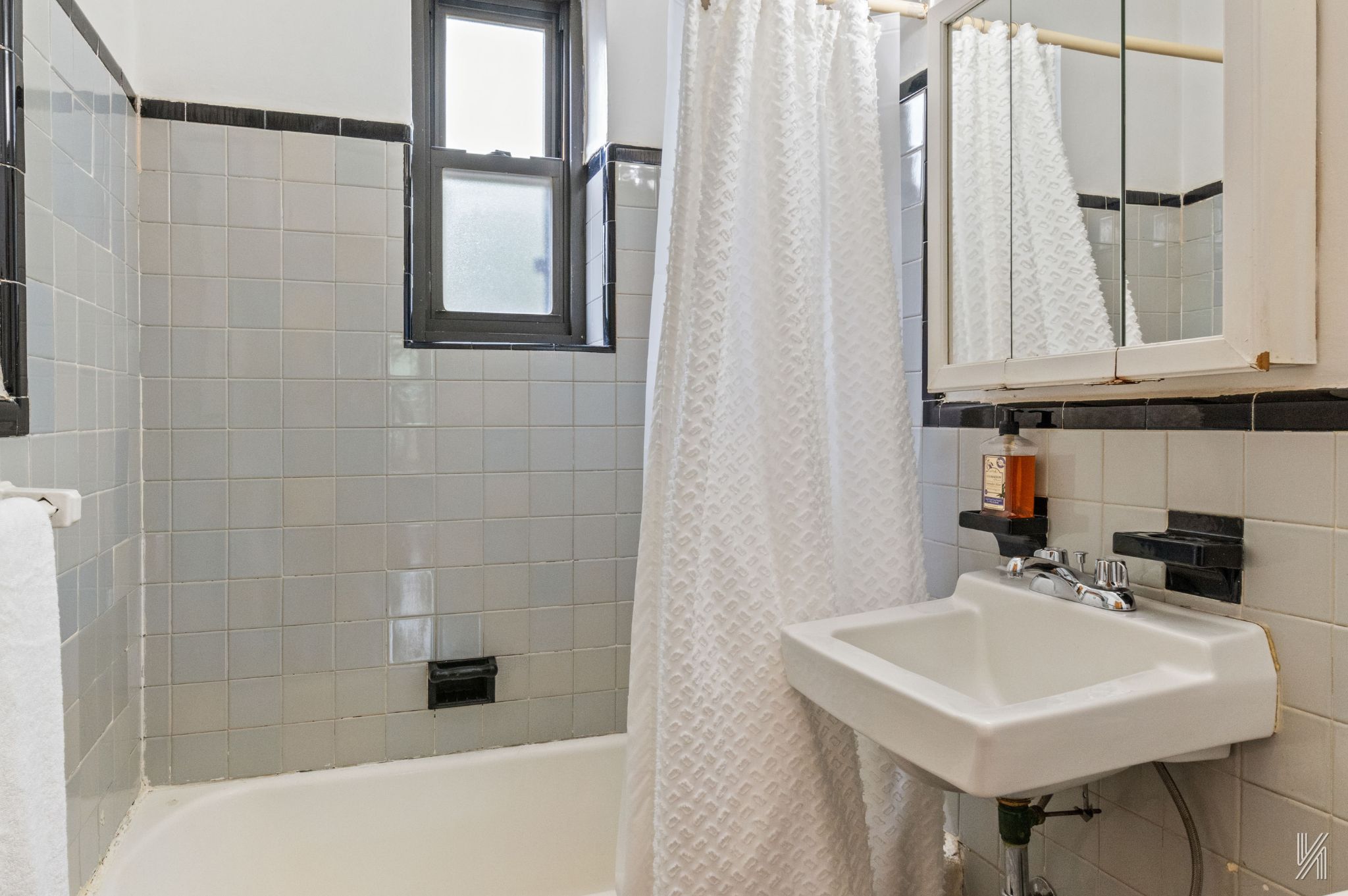 22-08 76th Street, Unit D2 Queens, NY 11370 - Photo 18 of 20 a bathroom with a sink a vanity and a shower