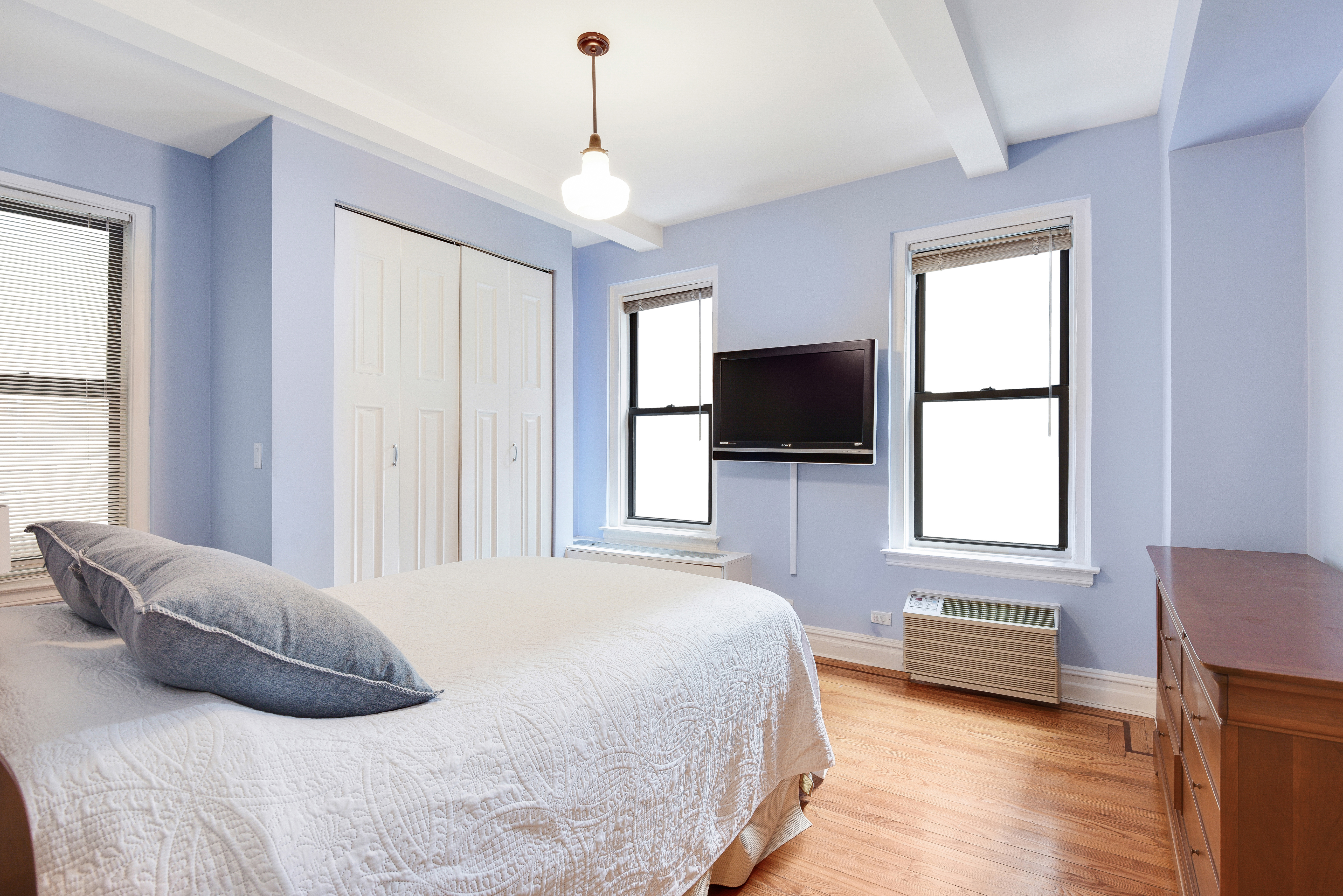 321 West 90th Street, Unit 2F Manhattan, NY 10024 - Photo 8 of 16 a bedroom with a bed and a flat screen tv