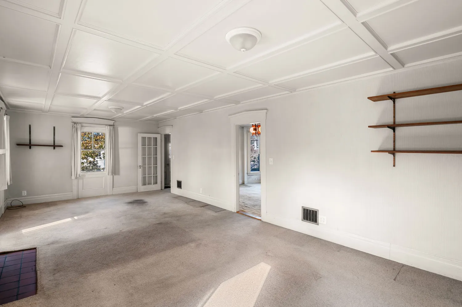 an empty room with fireplace and windows