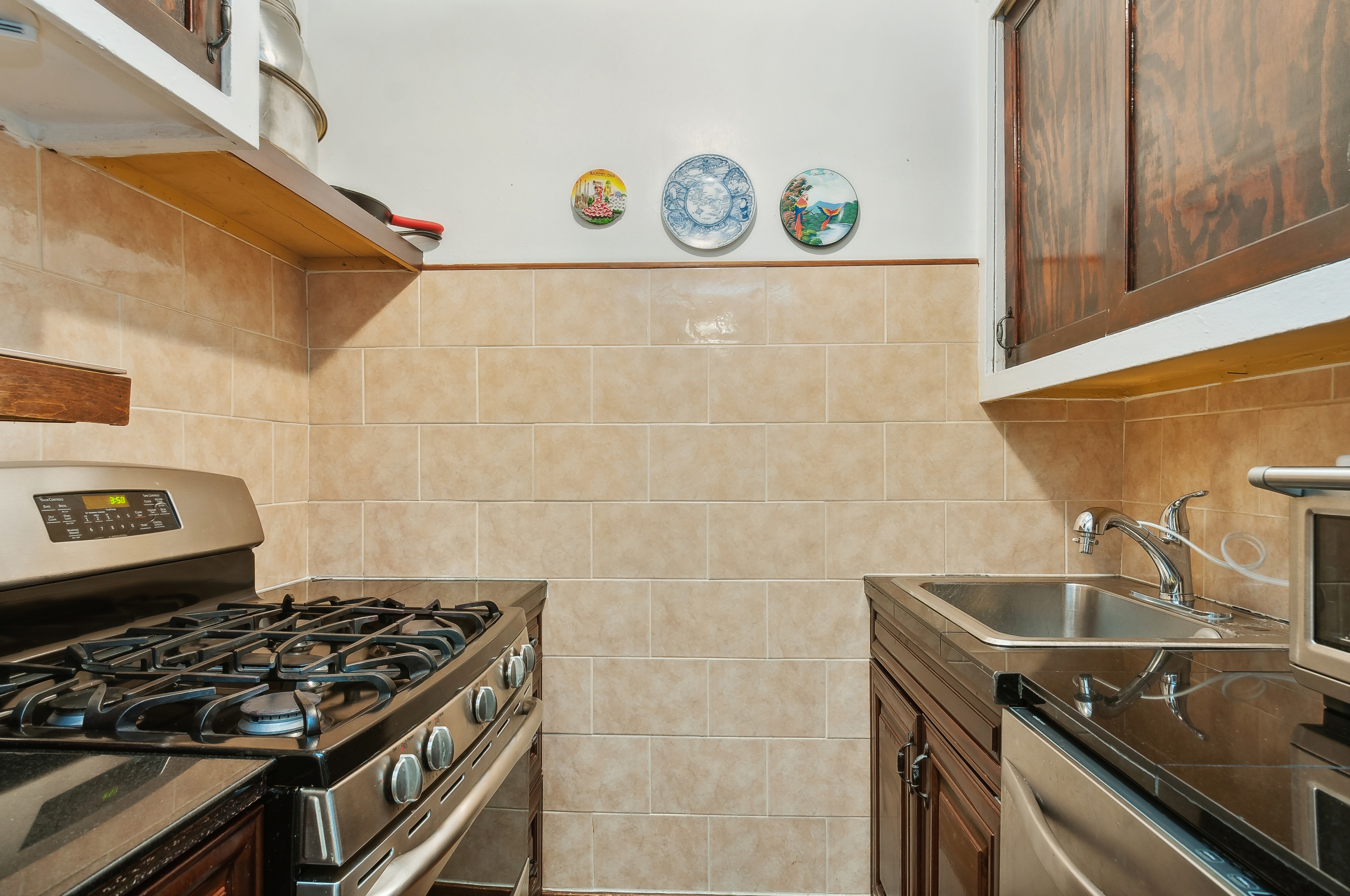408 West 34th Street, Unit 1F Manhattan, NY 10001 - Photo 6 of 13 a kitchen that has a sink and a stove