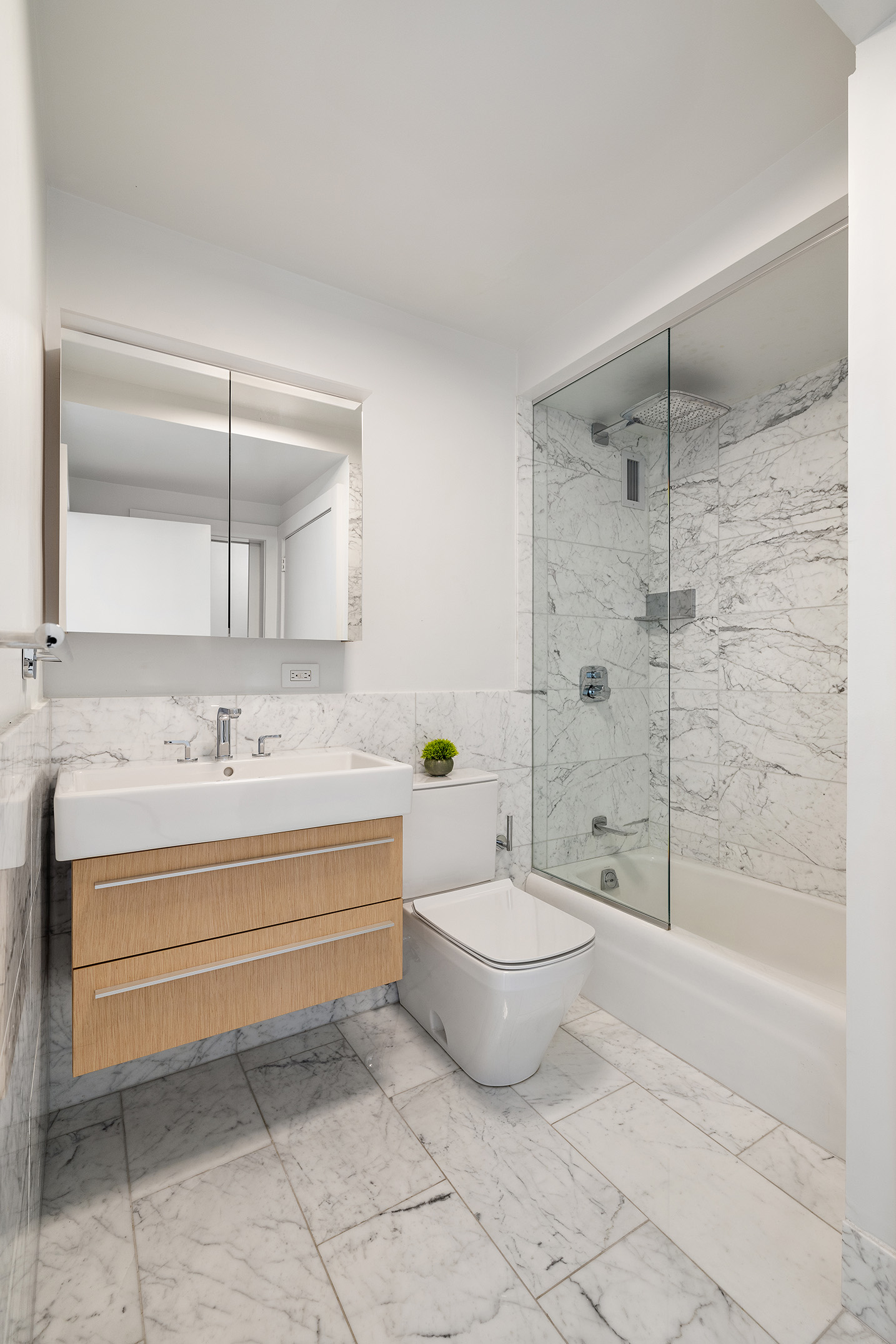 1080 Madison Avenue, Unit 6B Manhattan, NY 10028 - Photo 5 of 11 a bathroom with a sink toilet and shower