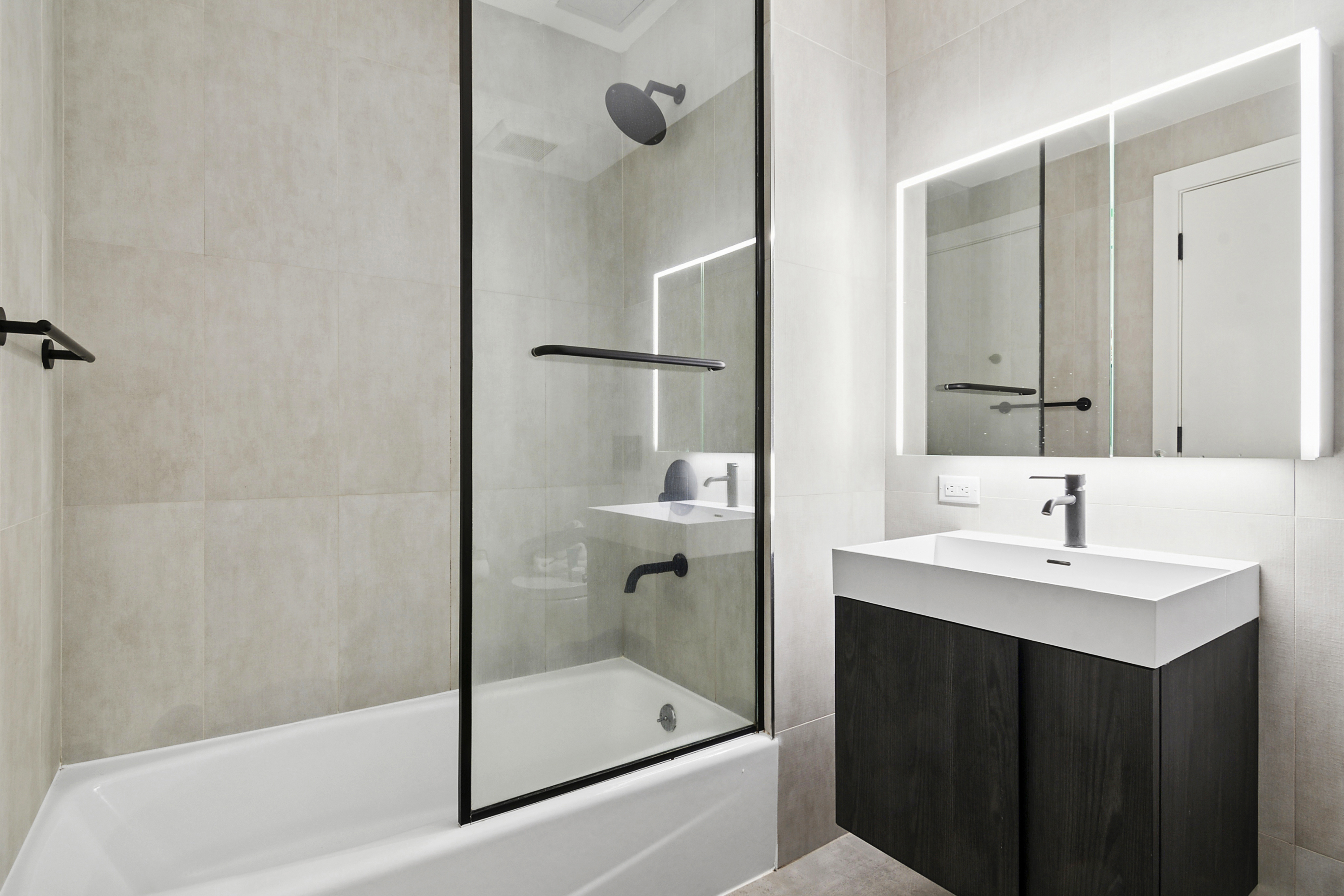 169 Huron Street, Unit 3A Brooklyn, NY 11222 - Photo 3 of 7 a bathroom with a bathtub shower sink and mirror