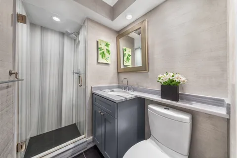 a bathroom with a sink toilet and shower